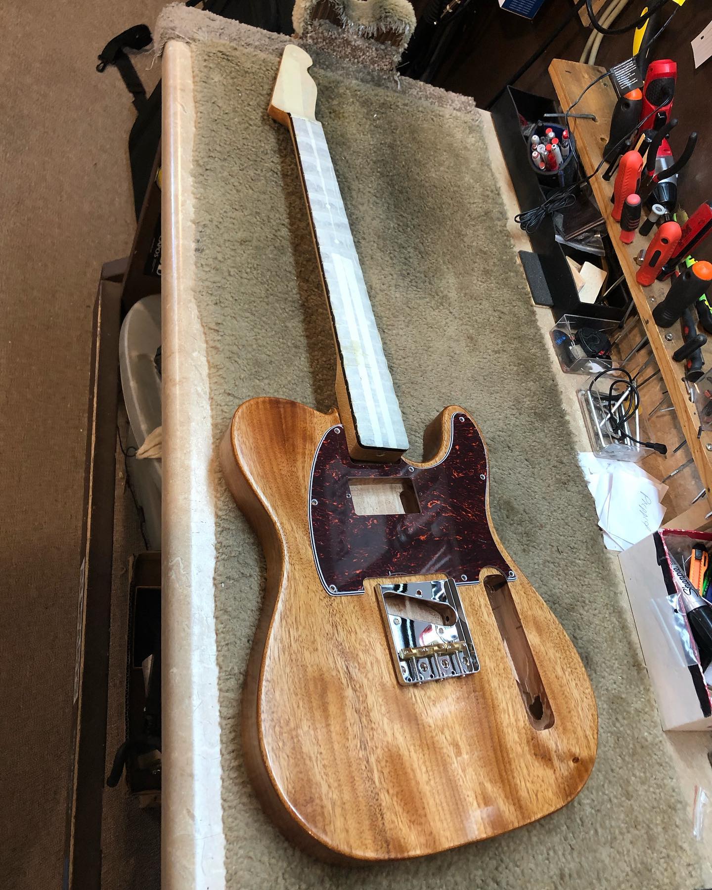 Telecaster guitar body with orange dye and Tru Oil finish