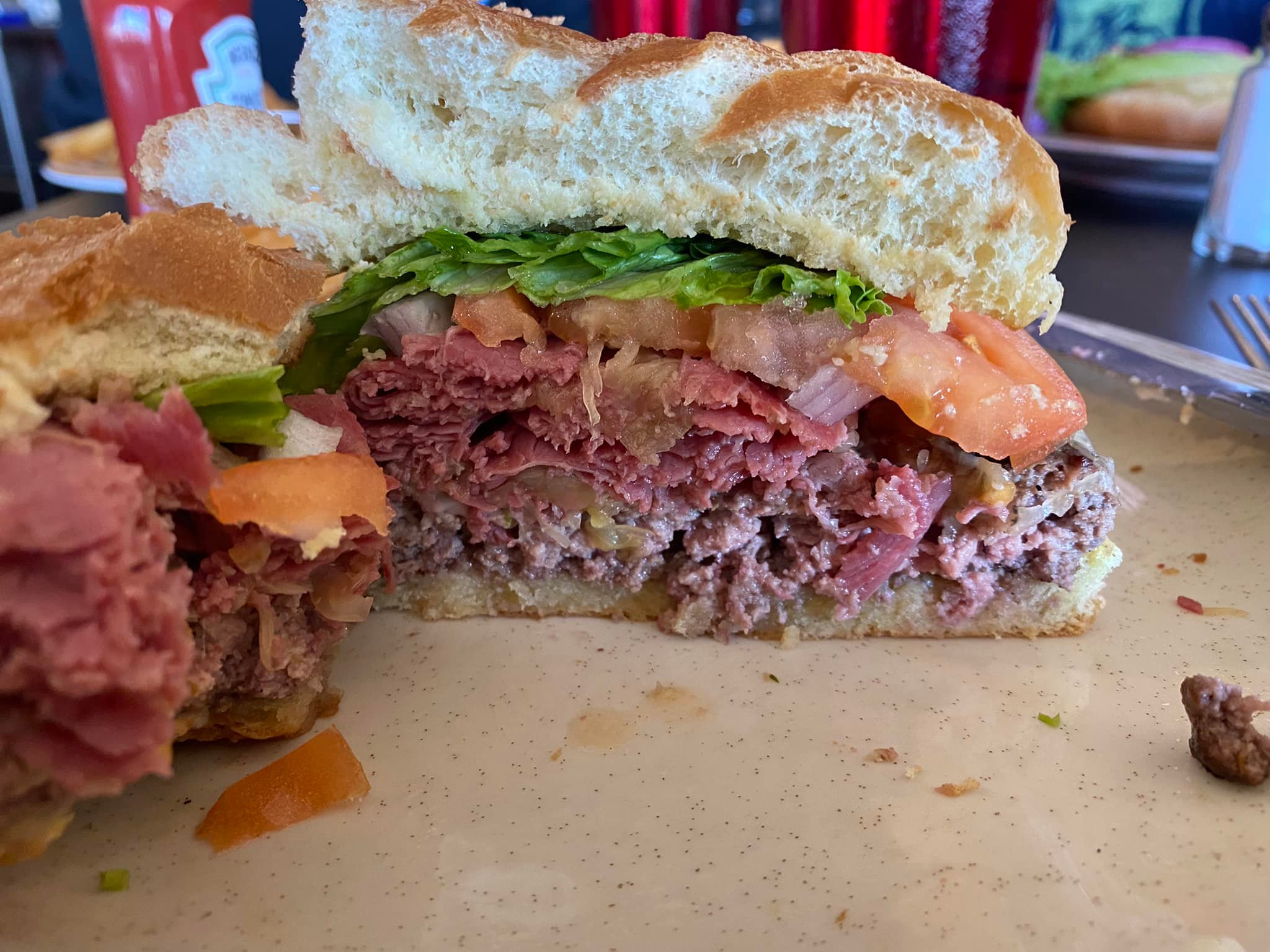Super beef sandwich with cheese and sauces at Worcester Eats