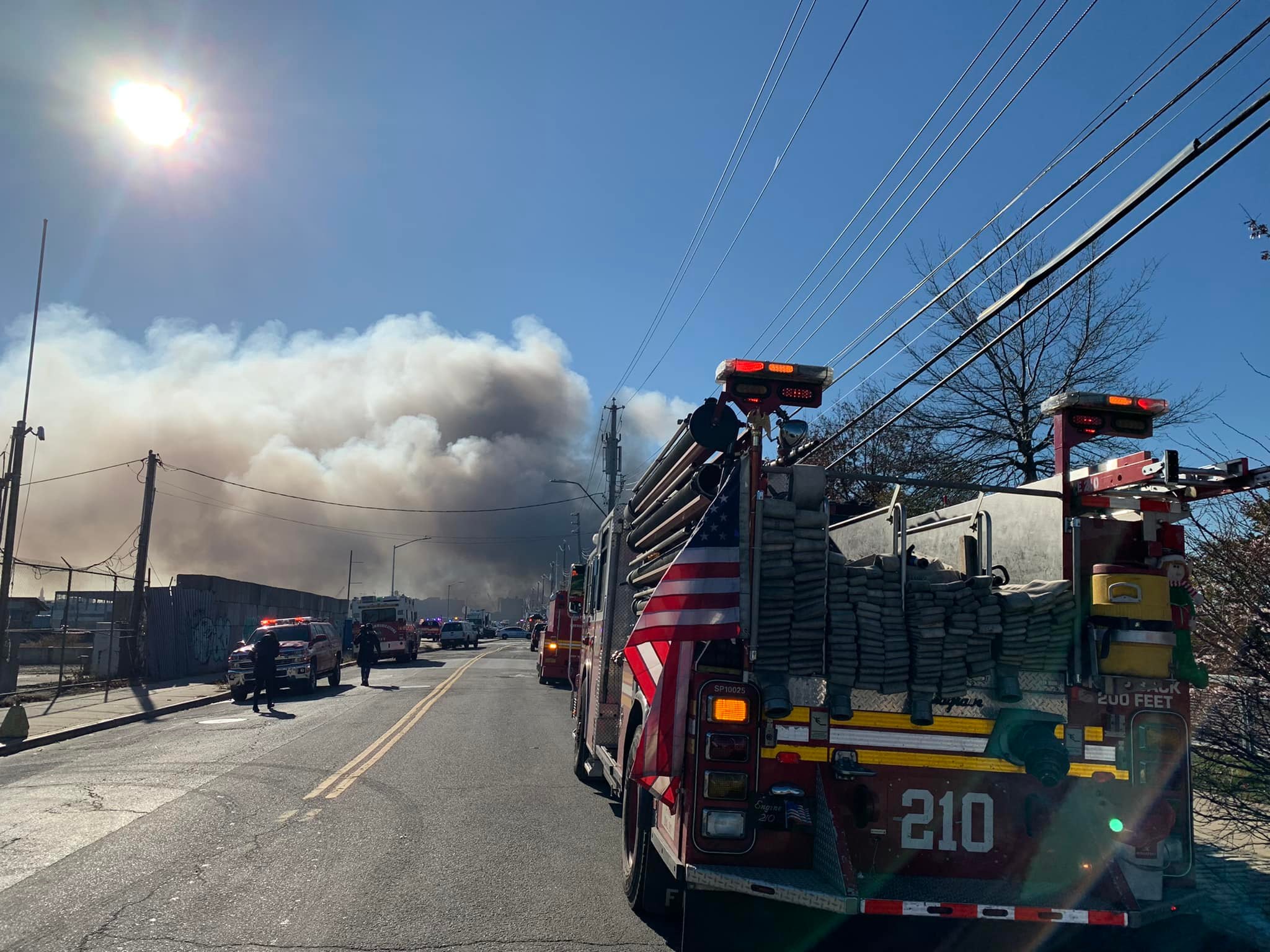 A five-alarm fire tore through a Brooklyn warehouse, injuring two