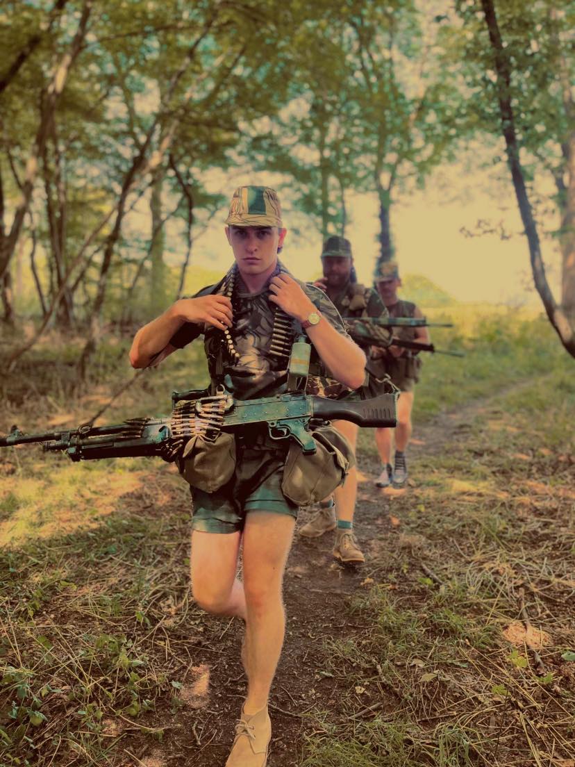 Rhodesian troopie taking aim with his MAG 58 in the bush circa 1975