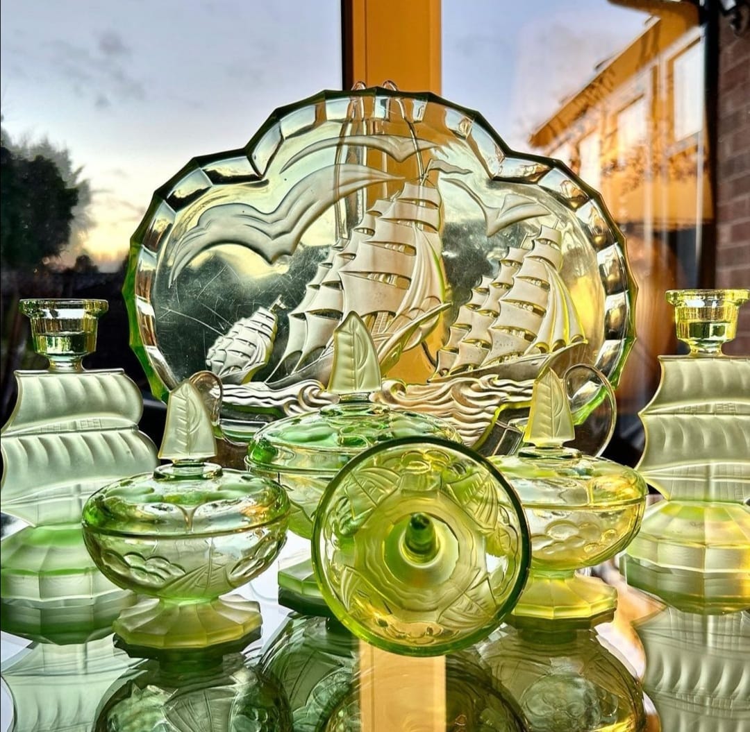 art deco green glass dressing table set Vintage vanity includes four coordinating pieces. The collection has a rectangular tray, a lidded trinket jar with a geometric finial, a perfume bottle with a matching geometric CATEGORY::mini