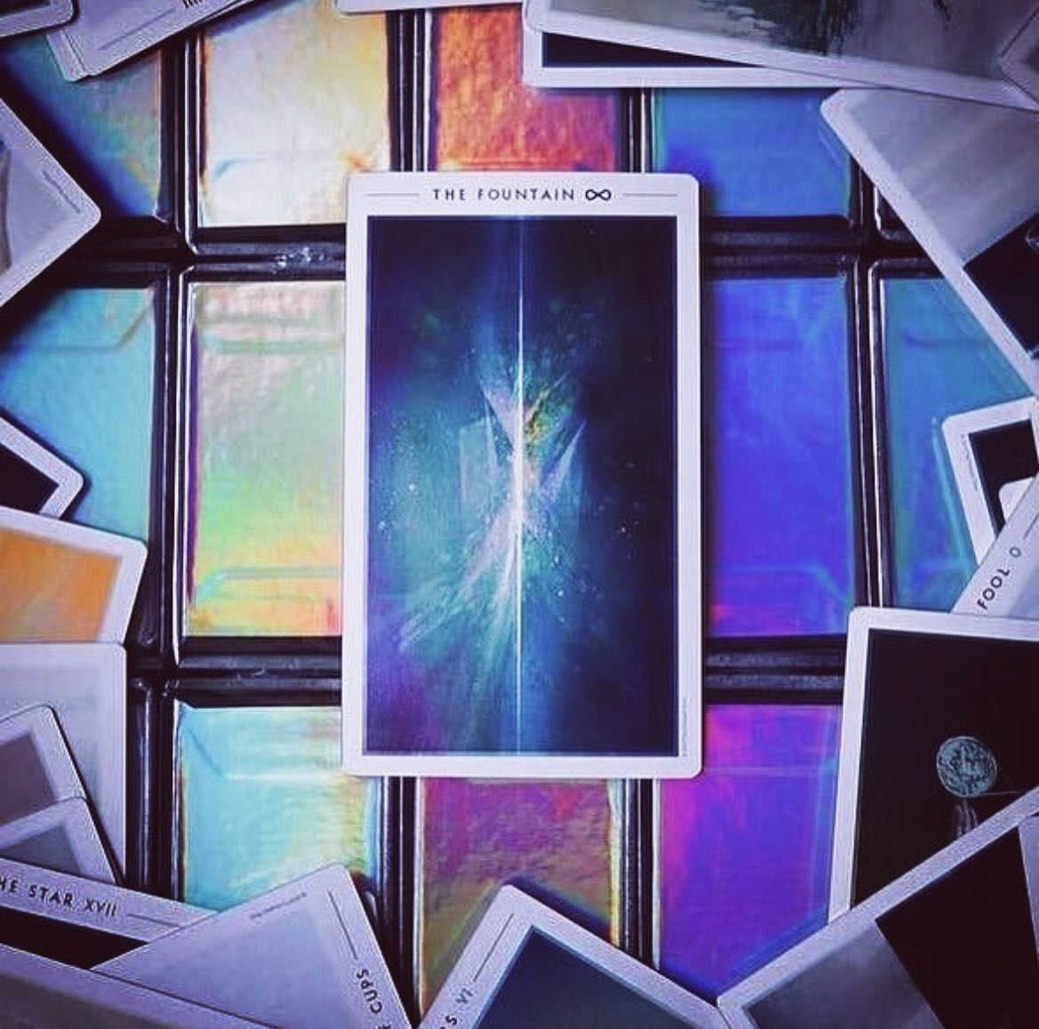 The Fountain Tarot card depicting a serene fountain surrounded by lush greenery, symbolizing renewal and eternal life.