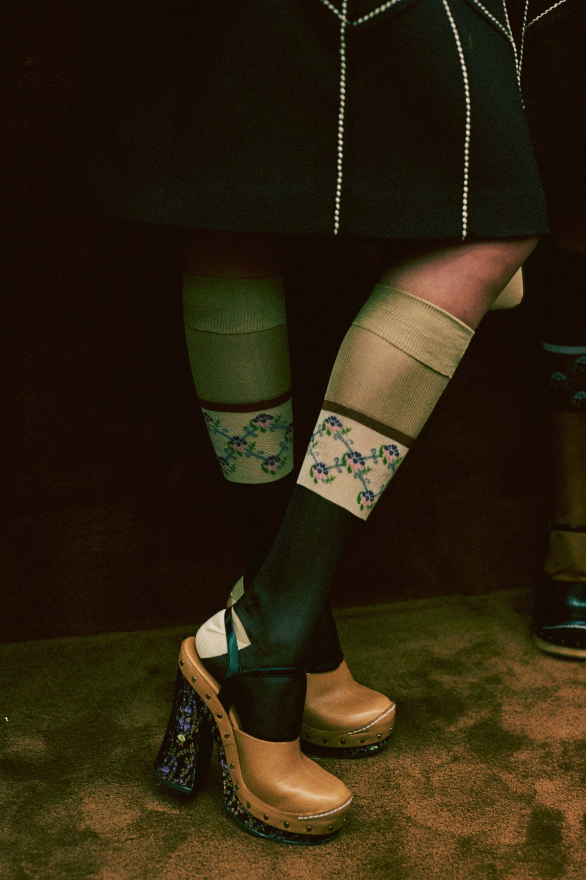 Leather clogs worn with silk jacquard socks from the Prada Spring