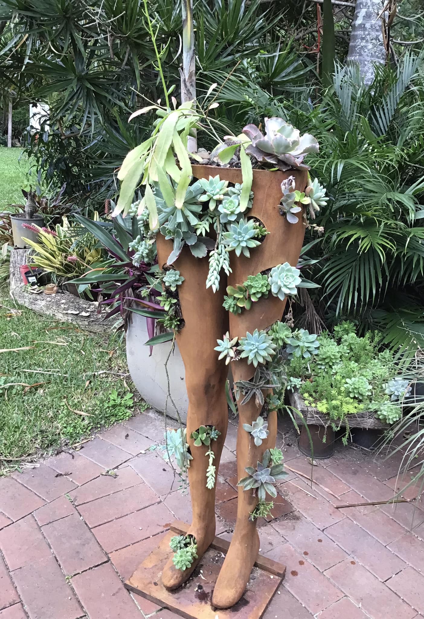 Upcycled mannequin decor with succulents and moss