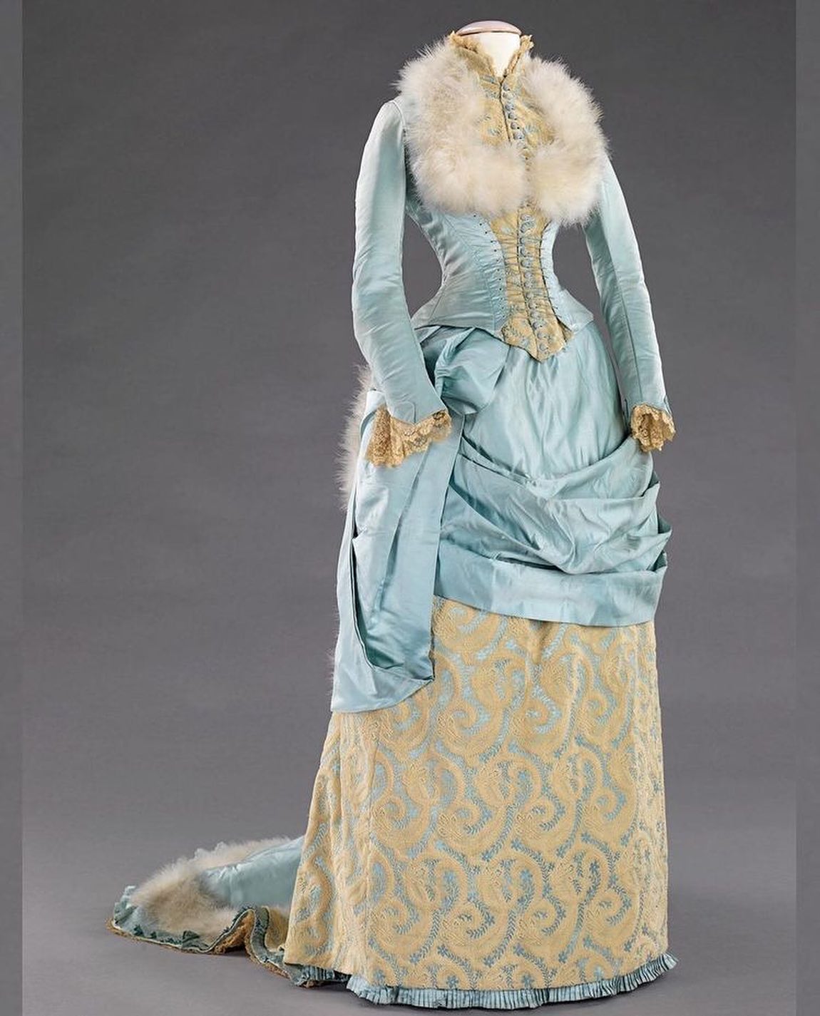 Victorian winter fashion in 1885 ice-blue silk evening dress