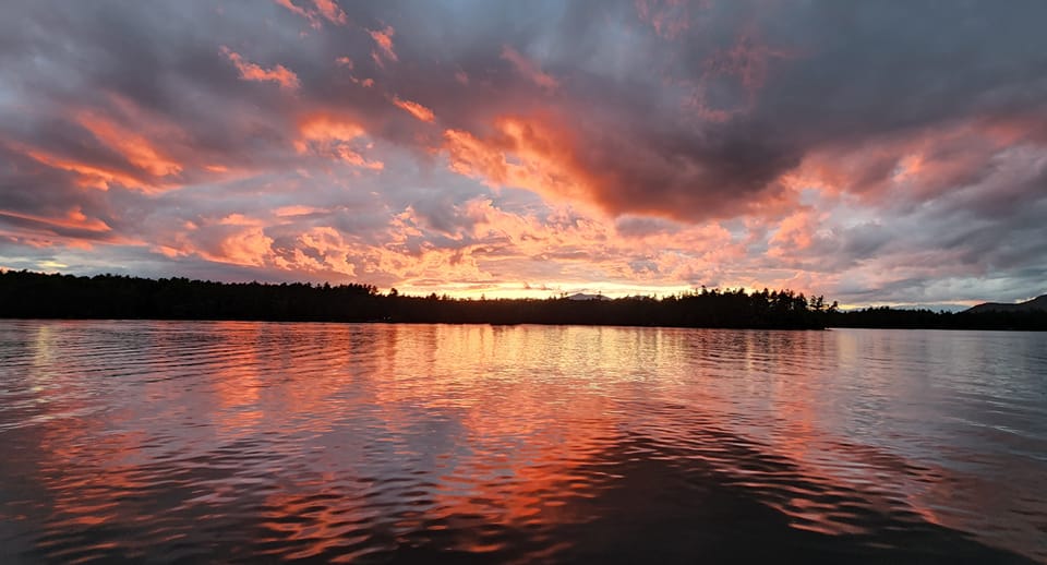 Stunning sunset over Cathedral Ledge and Echo Lake in Conway, New