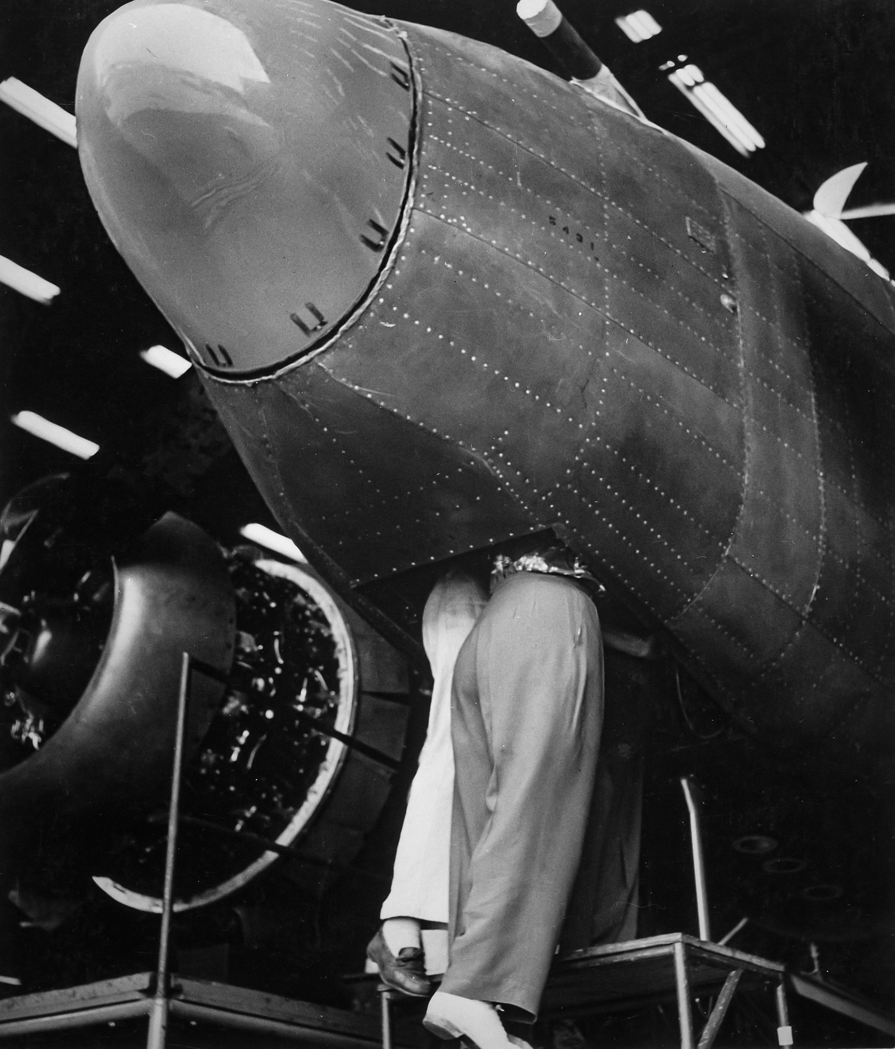 Workers rotate the propeller of a newly built Lockheed PV-1