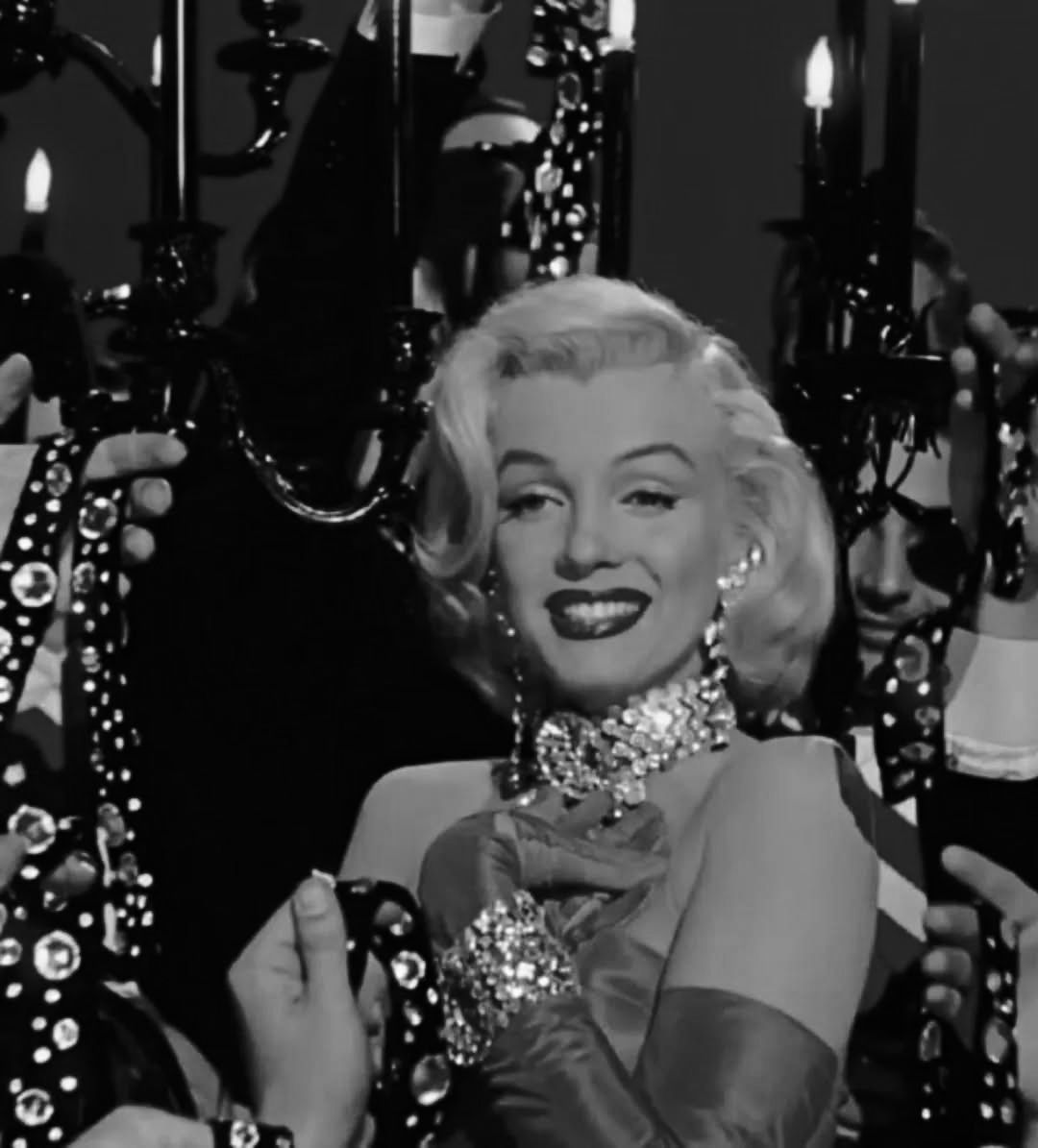open lace back dress Marilyn Monroe in red dress examining diamond jewellery - Framed Picture