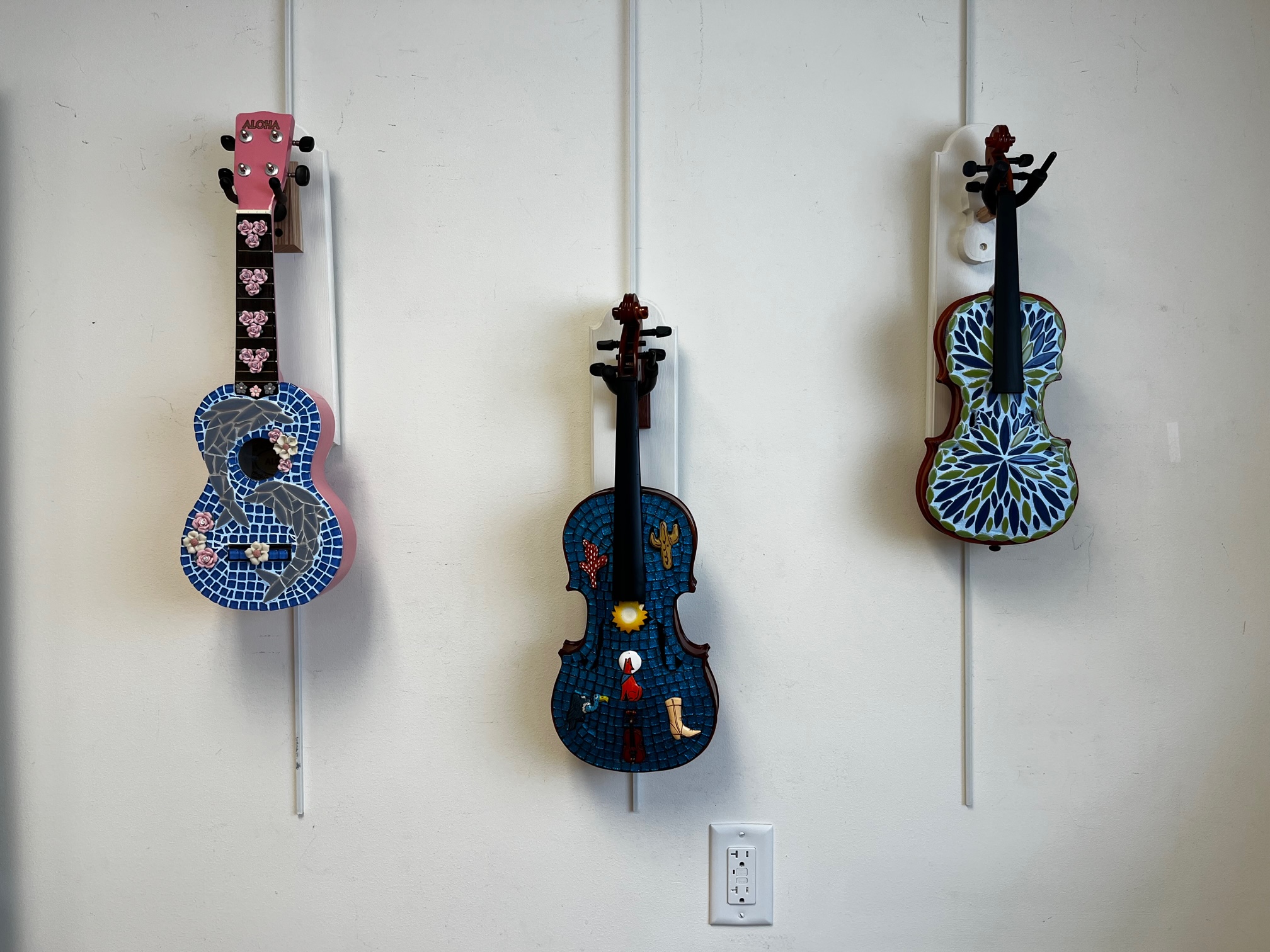 Mosaic art exhibition made from repurposed violins