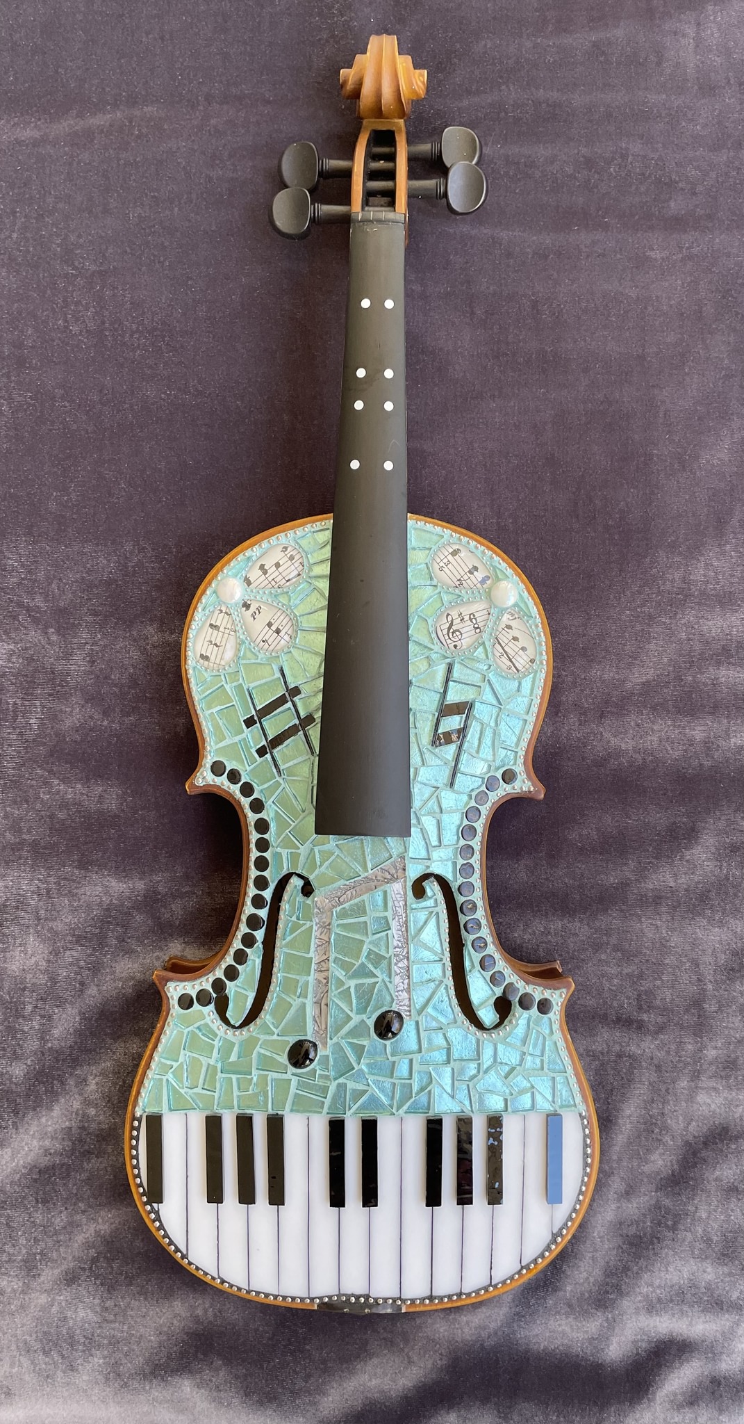 Mosaic art exhibition made from repurposed violins