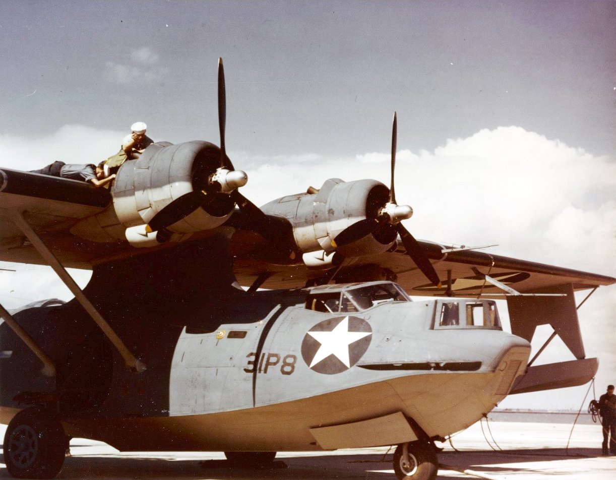 The War - Crewmen performing engine maintenance on a PBY-5A of VP-31 ...