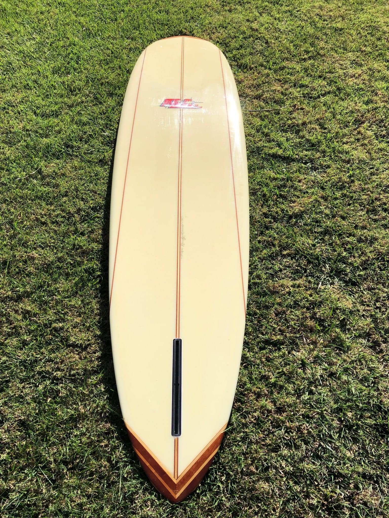 Riding a classic 8-foot surfboard shaped by Randy Rarick