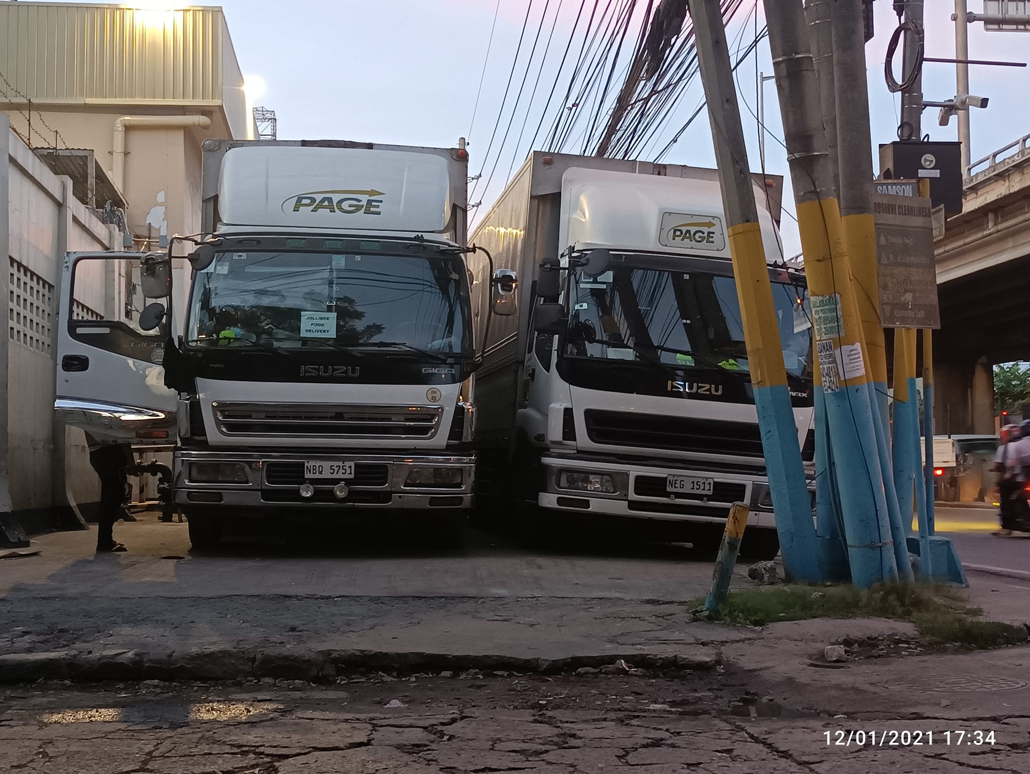 Isuzu Giga and Freightliner Columbia trucks on the road