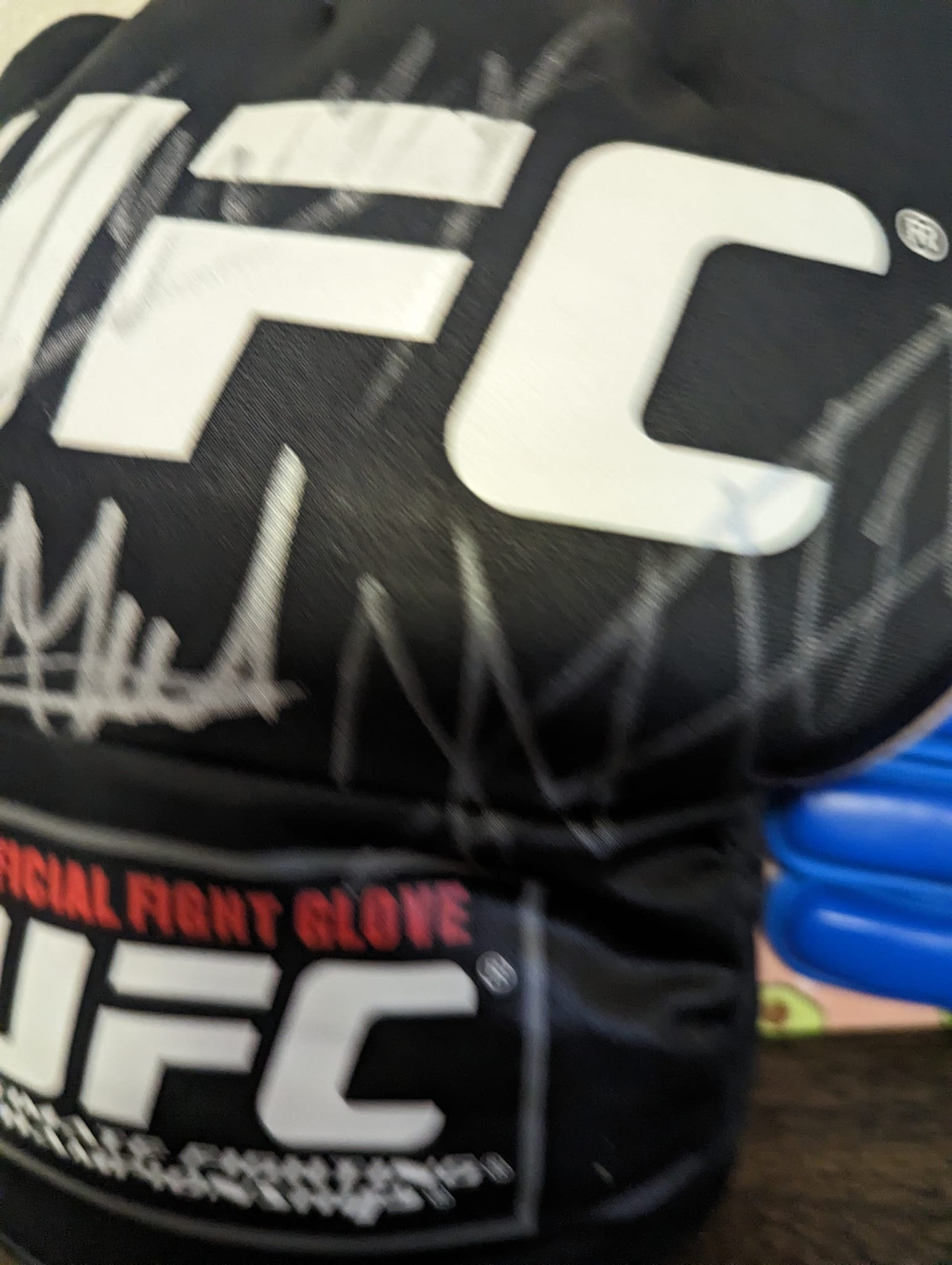 Who signed this UFC glove besides Robbie Lawler?