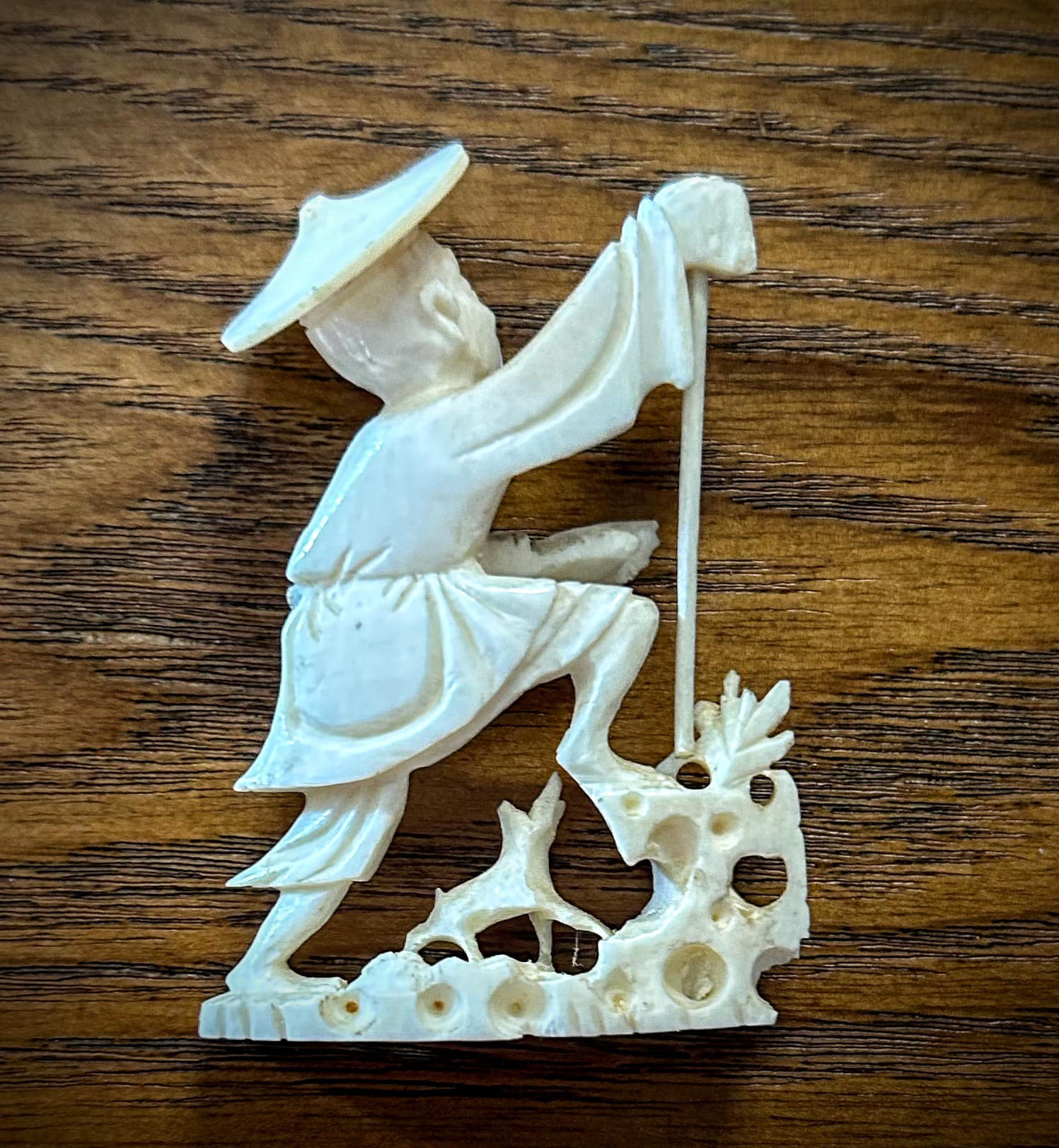asian fisherman with net fish figurine ivory hand carved Small of holding A carved ivory figure of