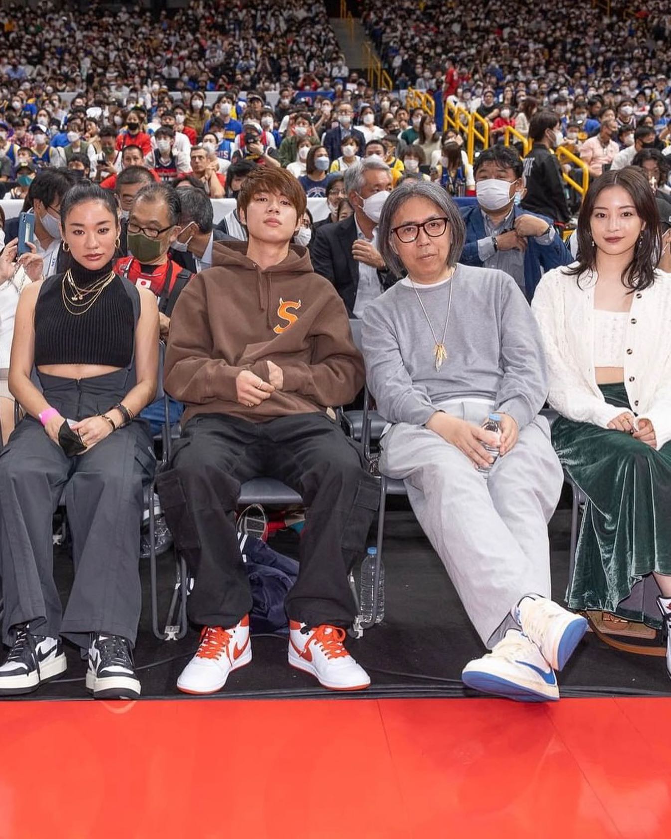 Travis Scott wearing a retro Tokyo Verdy shirt at the basketball