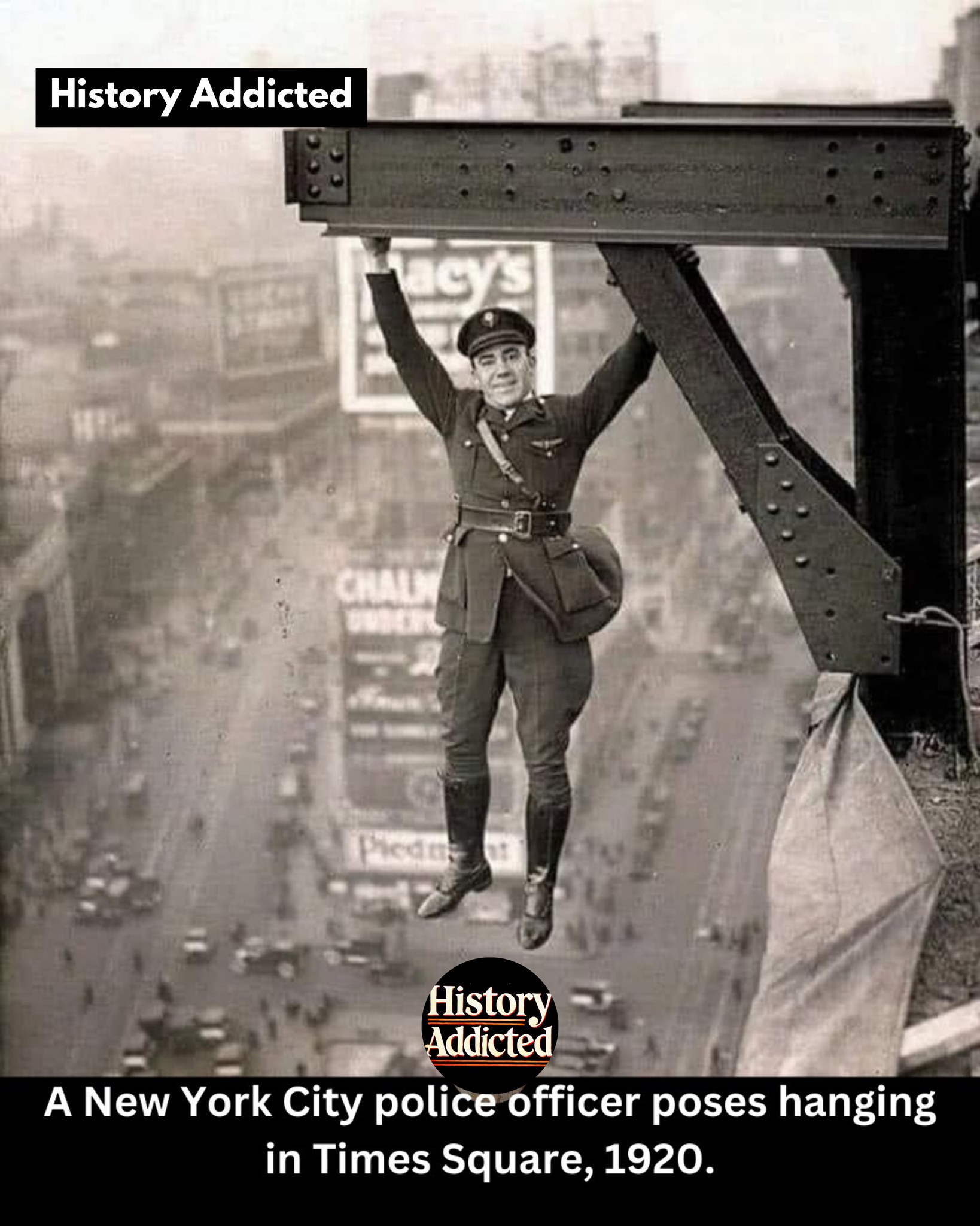 A New York City police officer poses hanging in Times Square, 1920