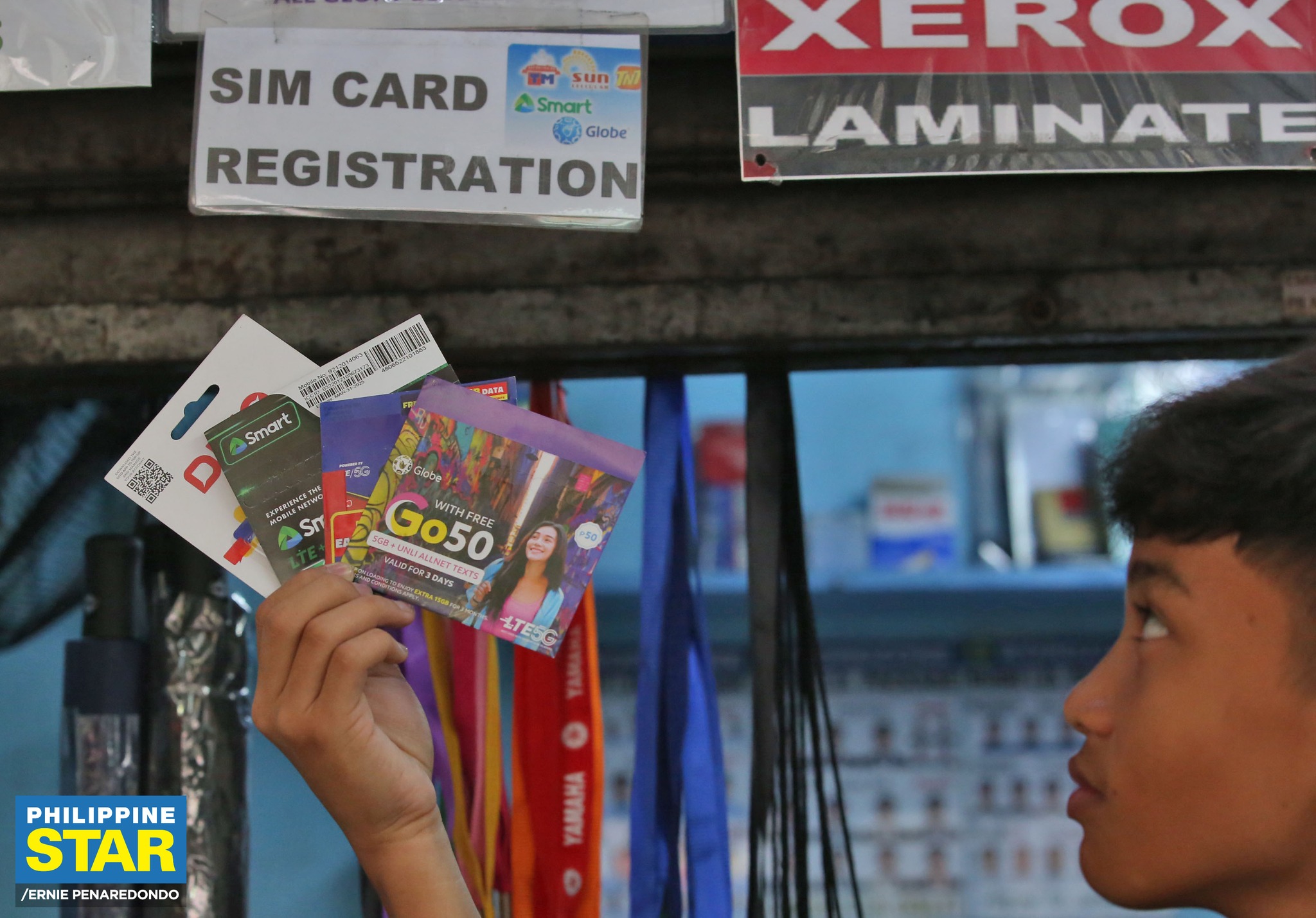 Philippine Star - Vendors display their SIM card products...