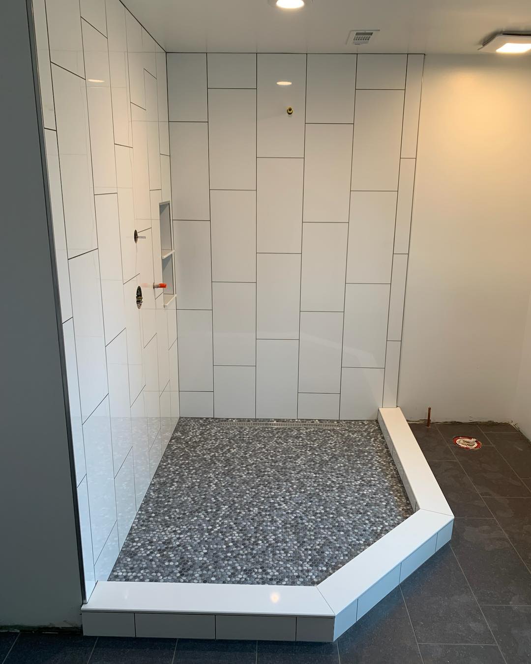IKC - Vertical tile application on these shower walls. #mosaictile # ...