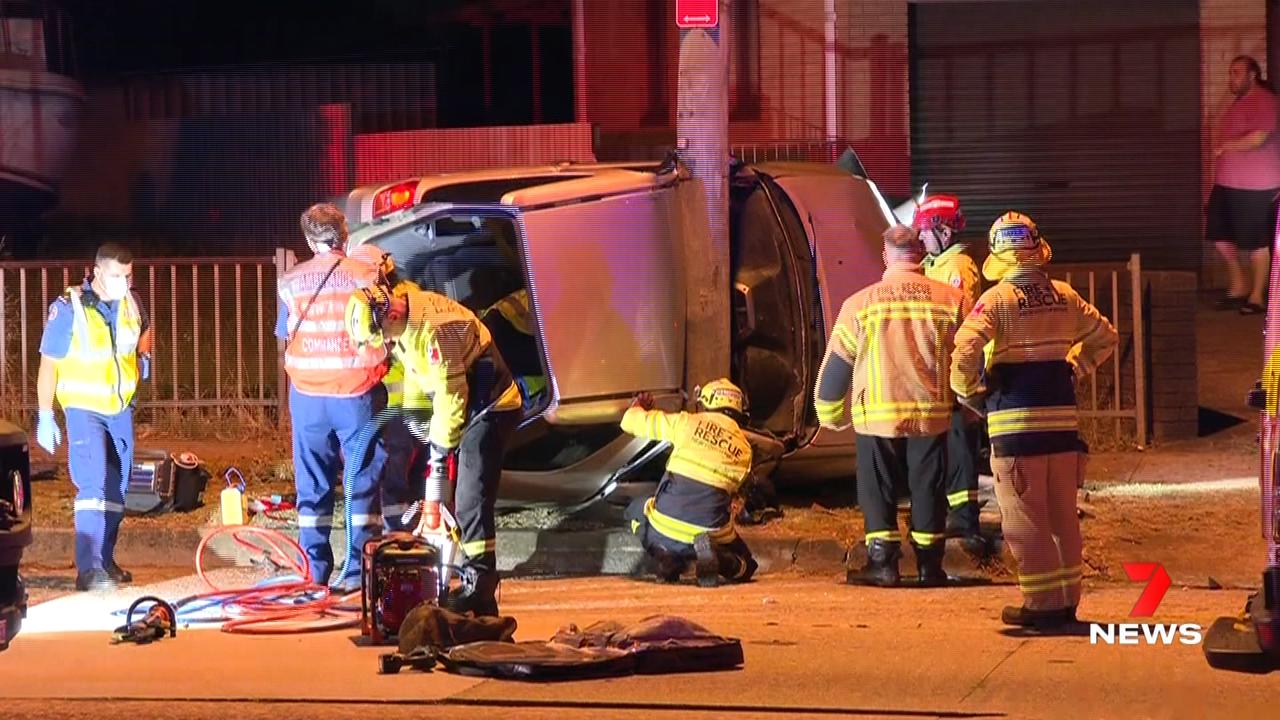 7NEWS Sydney - A car has rolled and collided with a pole on the Hume ...