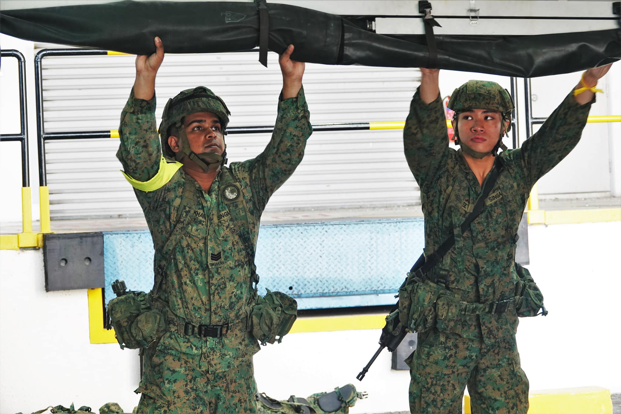 The Singapore - 3SG Ameenkhan guiding trainees on the deployment of the ...