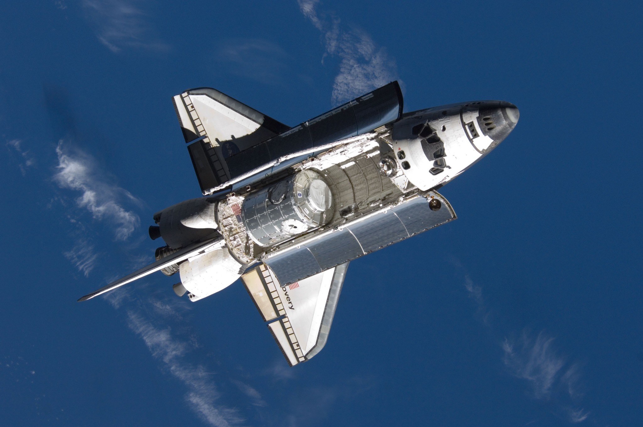 Blast - Backdropped by a blue and white Earth, Space Shuttle Discovery ...