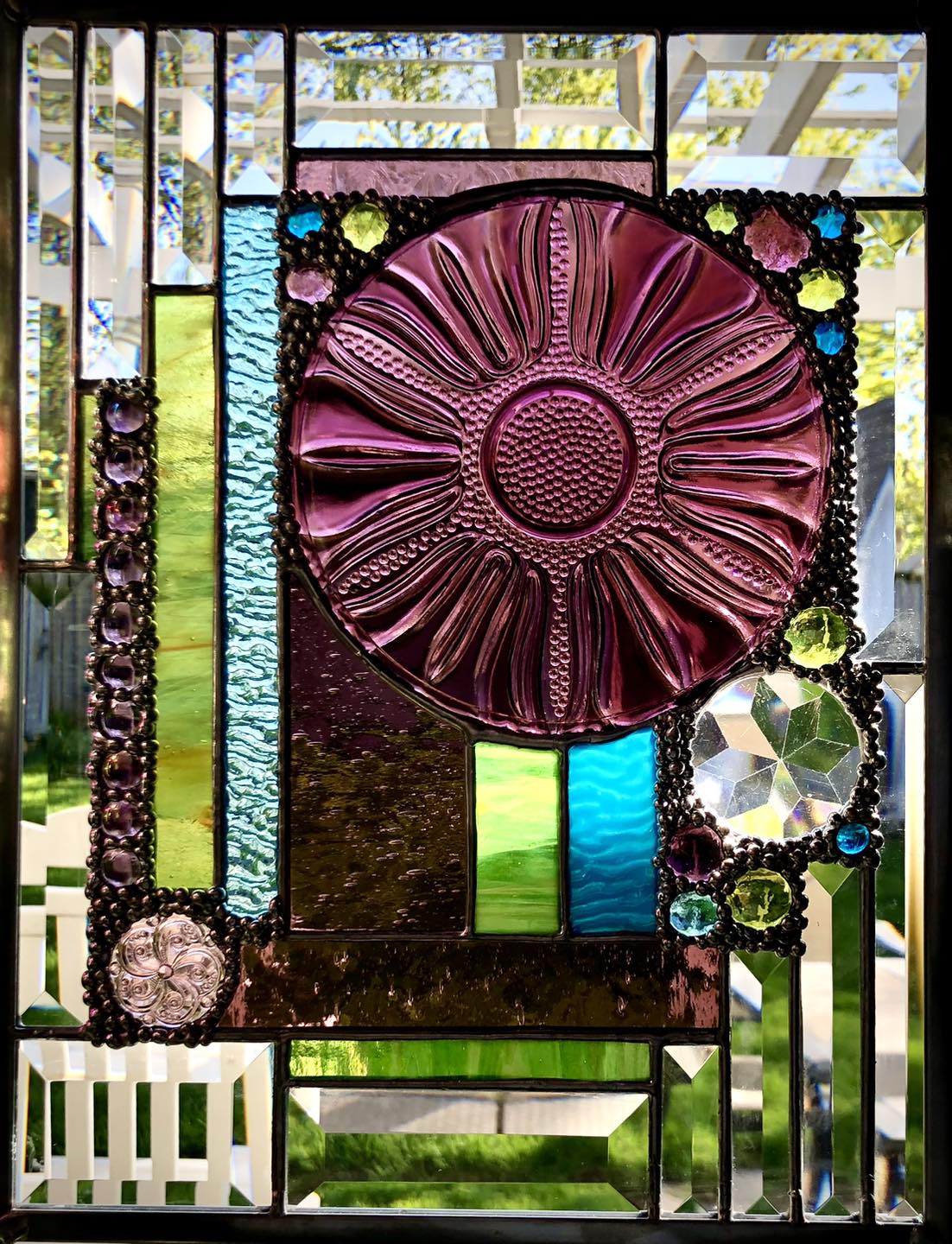 What glass has pink, blue, green, and purple colors?