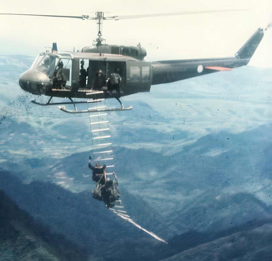 Military - Soldiers climbing up a Huey during the Vietnam War. | Facebook