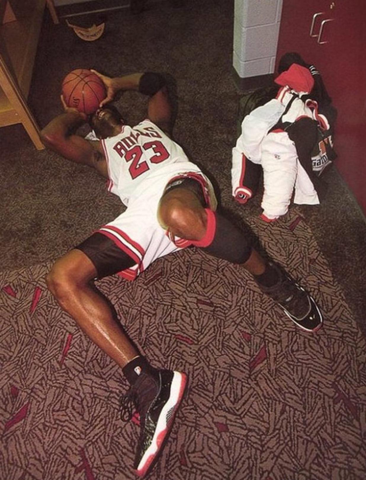1996) An emotional Jordan on the locker room floor after winning 