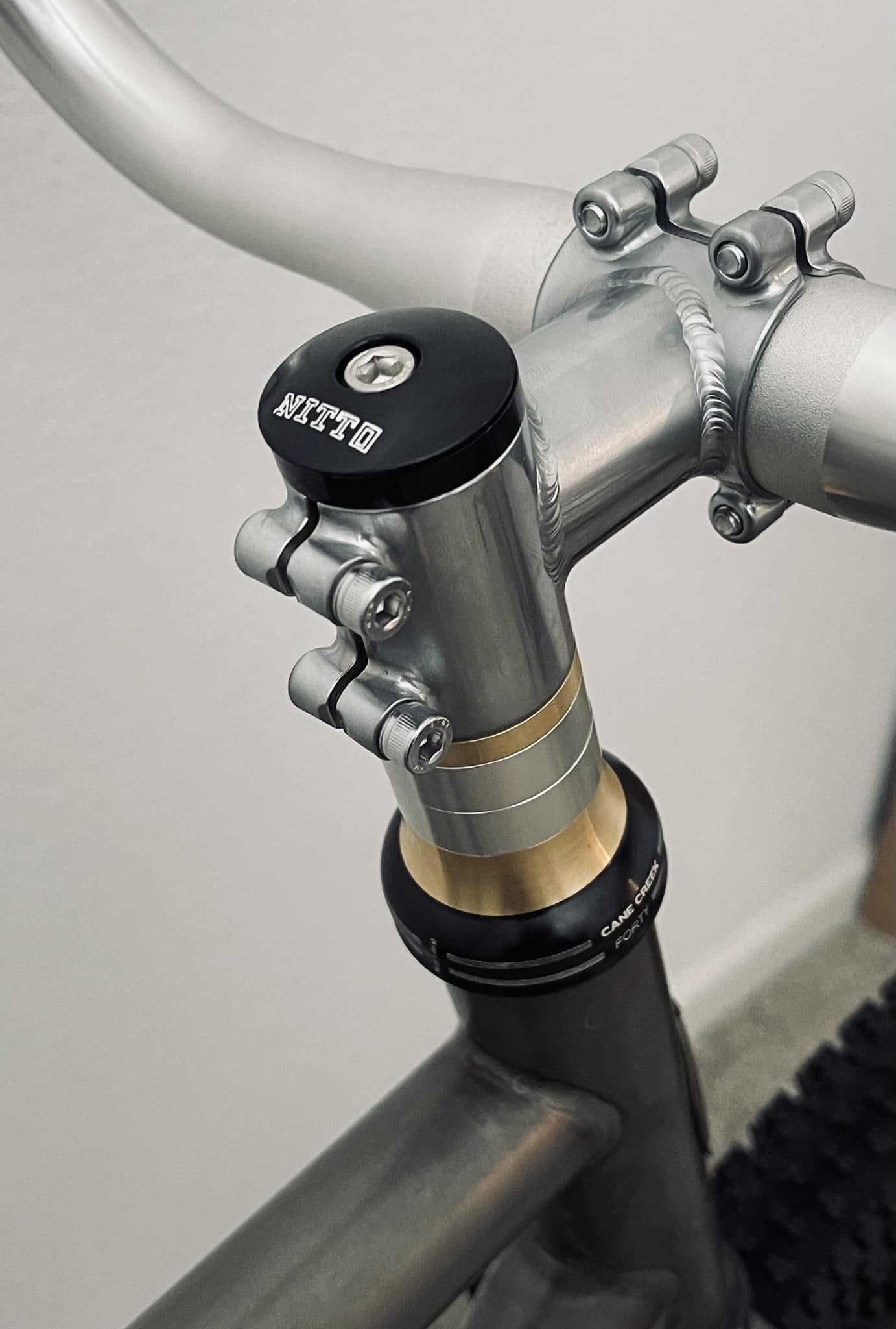 NITTO UI-12 stem and Blue Lug brass spacers on a Crust bike