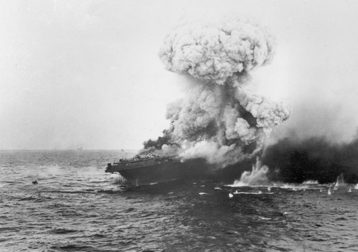U.S. sailors abandon the aircraft carrier USS Lexington after she