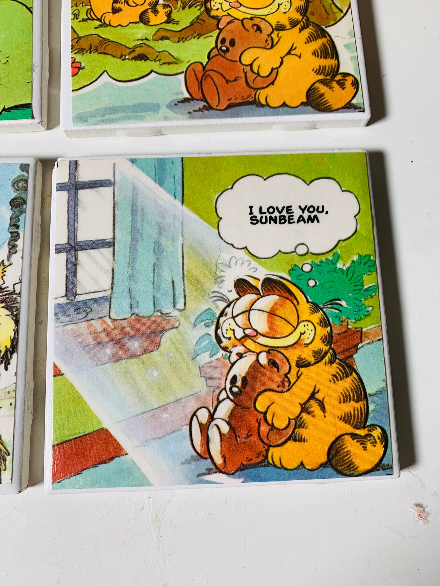 I started some coasters using pages from a vintage Garfield book
