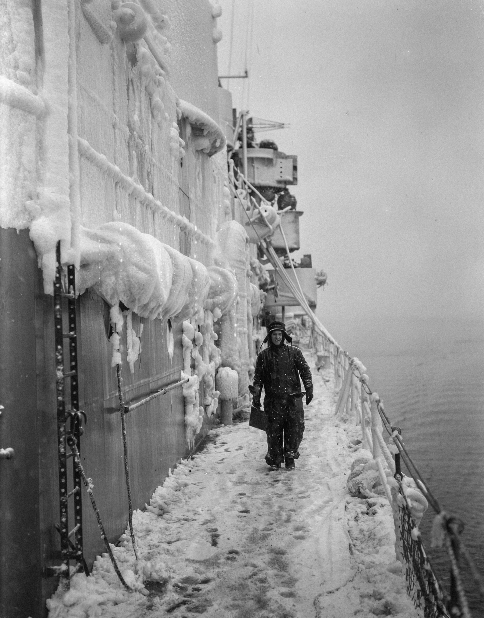 I love - A member of crew on the snow covered deck of British light ...