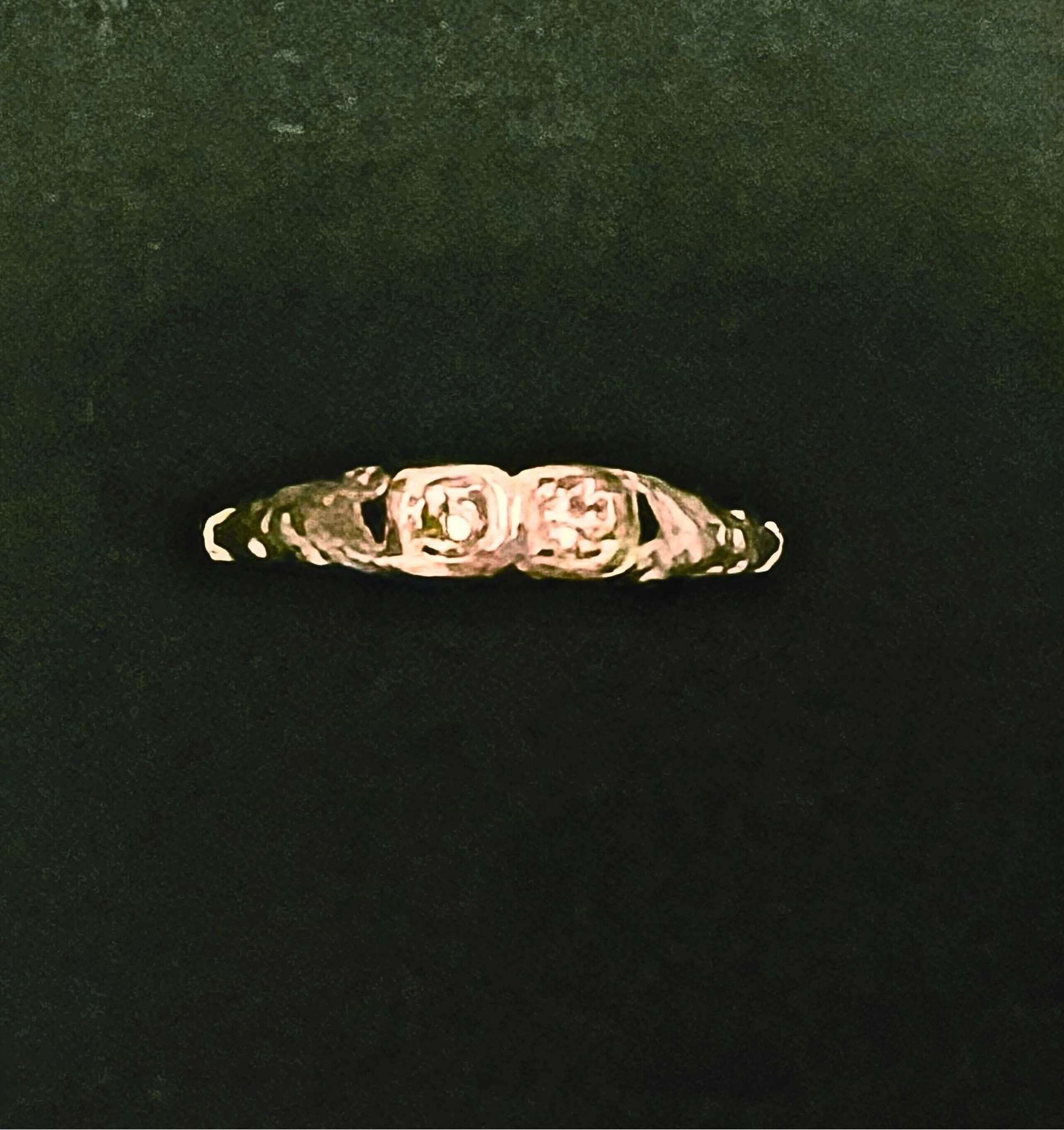 What is the origin and value of a vintage ring with intertwined 