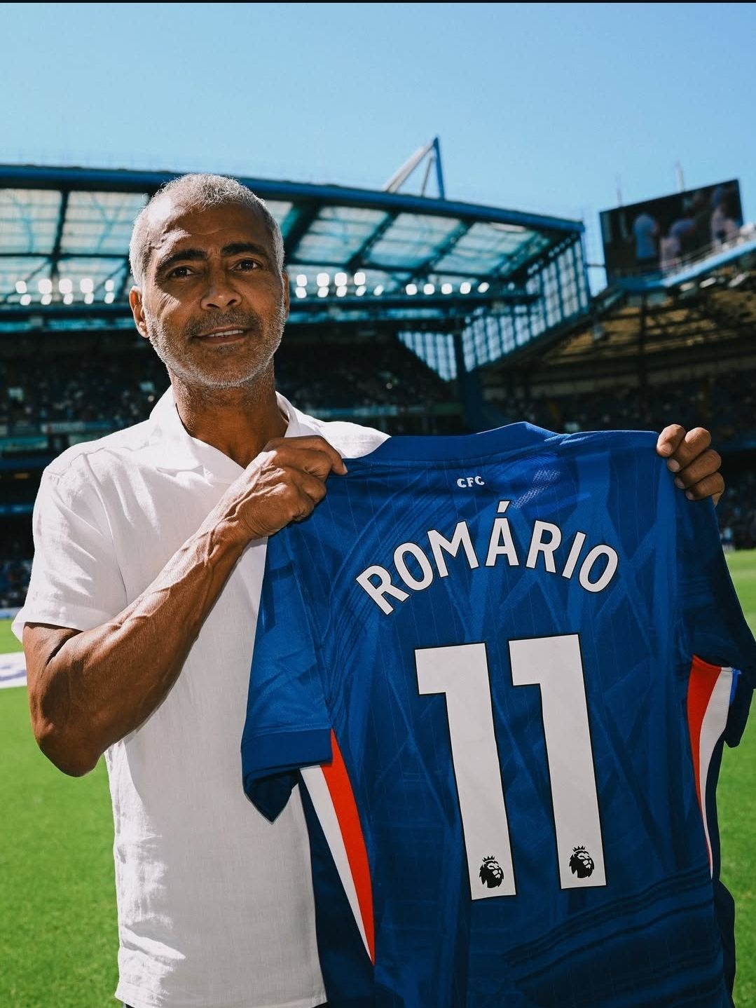 Football legend Romario proudly holds his customized Chelsea