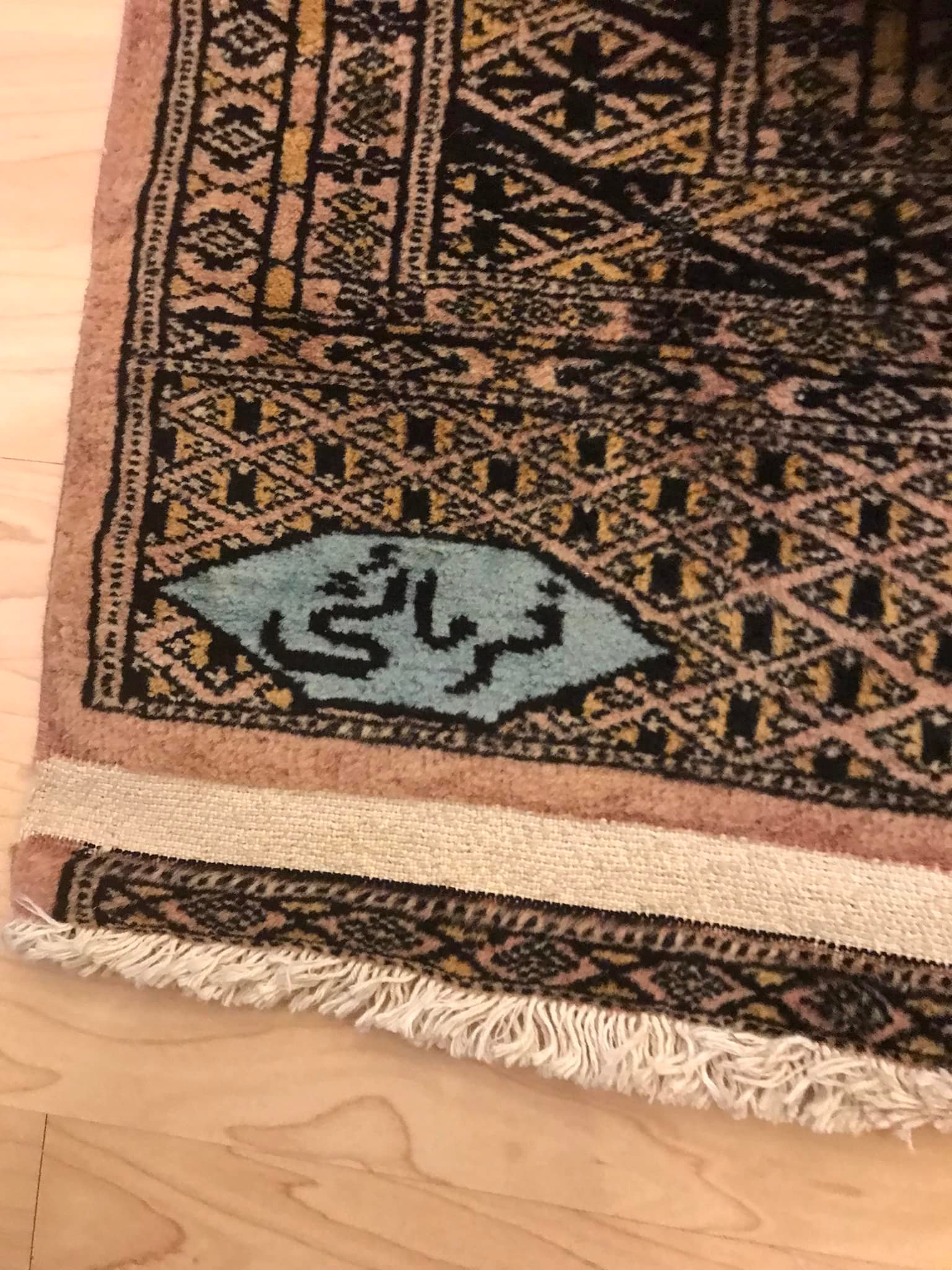 What is the origin and age of this handmade rug?
