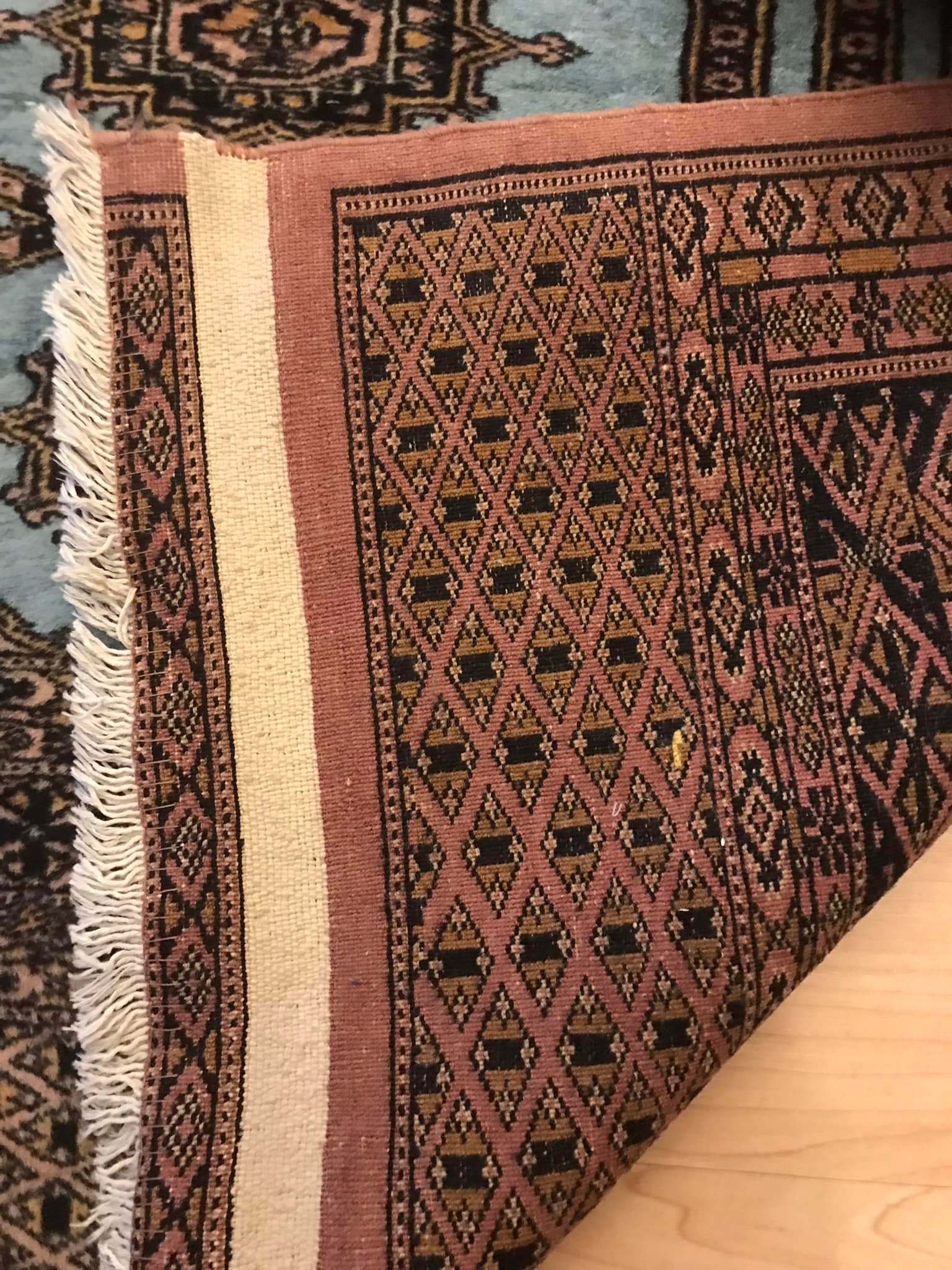 What is the origin and age of this handmade rug?