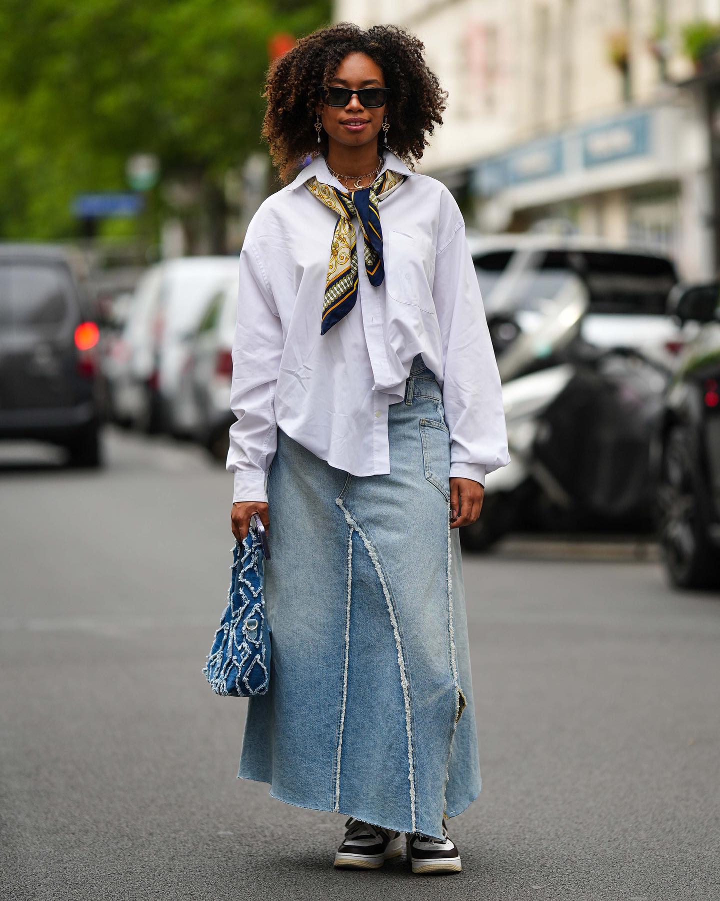 The denim skirt first materialised in the 1970s at the hands of people cutting up their old denim jeans. Since then, the wardrobe staple has evolved in numerous shapes, cuts, and sizes