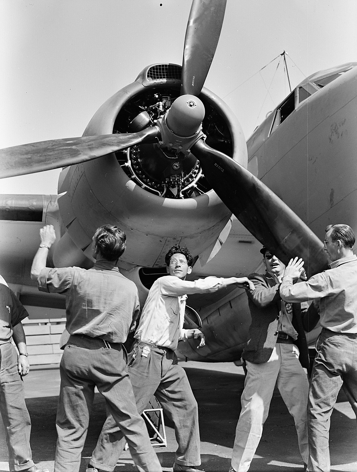 Workers rotate the propeller of a newly built Lockheed PV-1