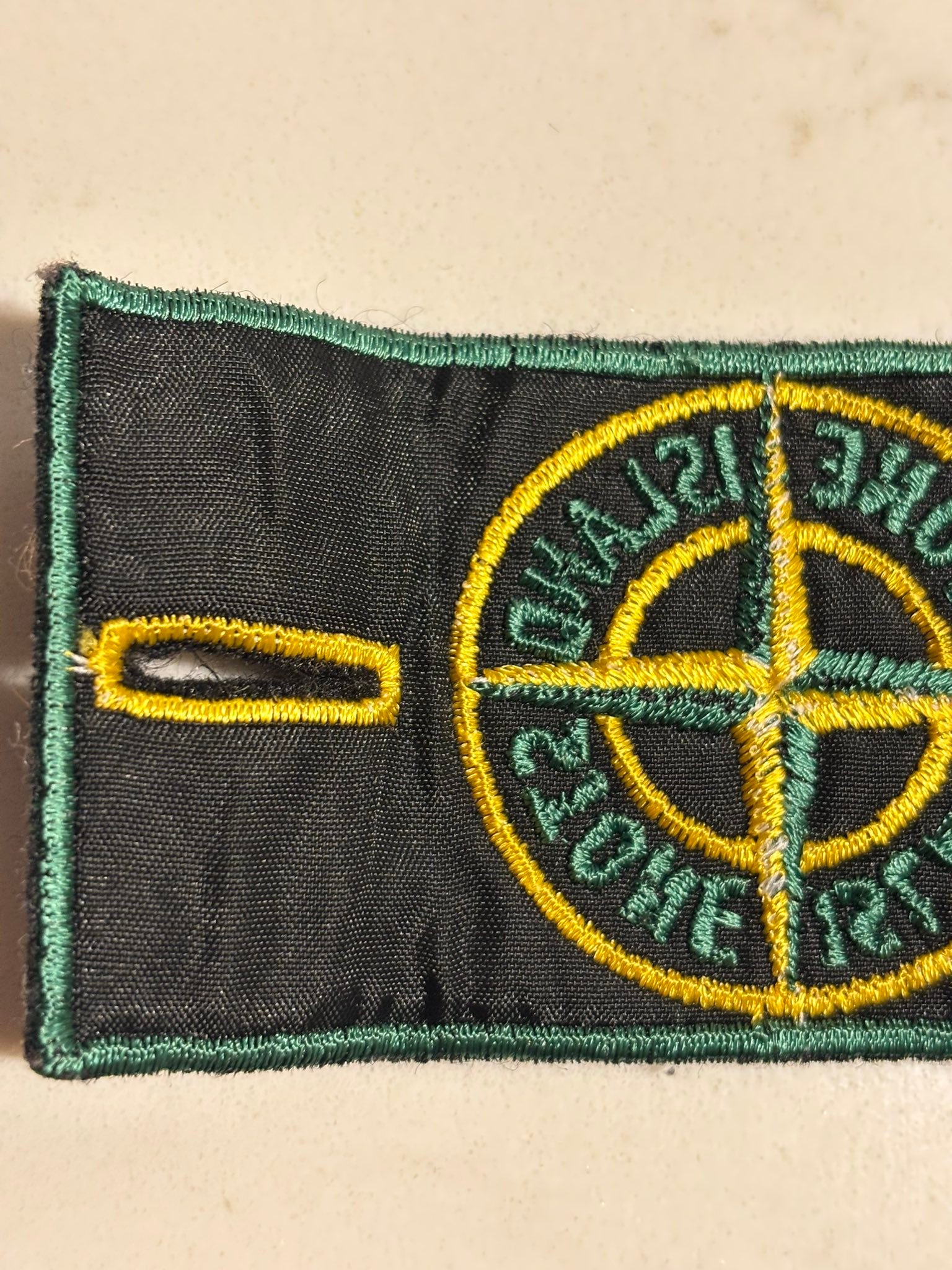 What is the Stone Island green edge badge with art number AW98?