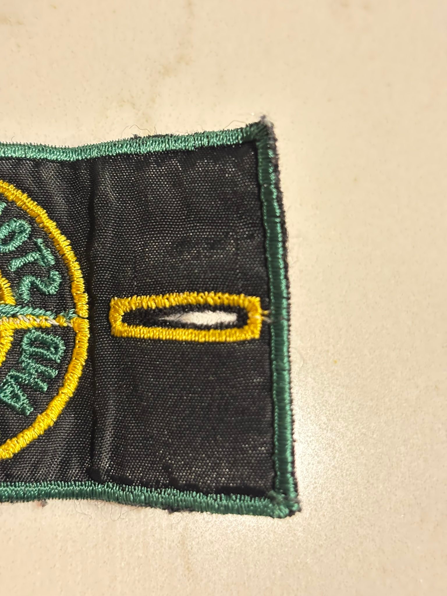 What is the Stone Island green edge badge with art number AW98?