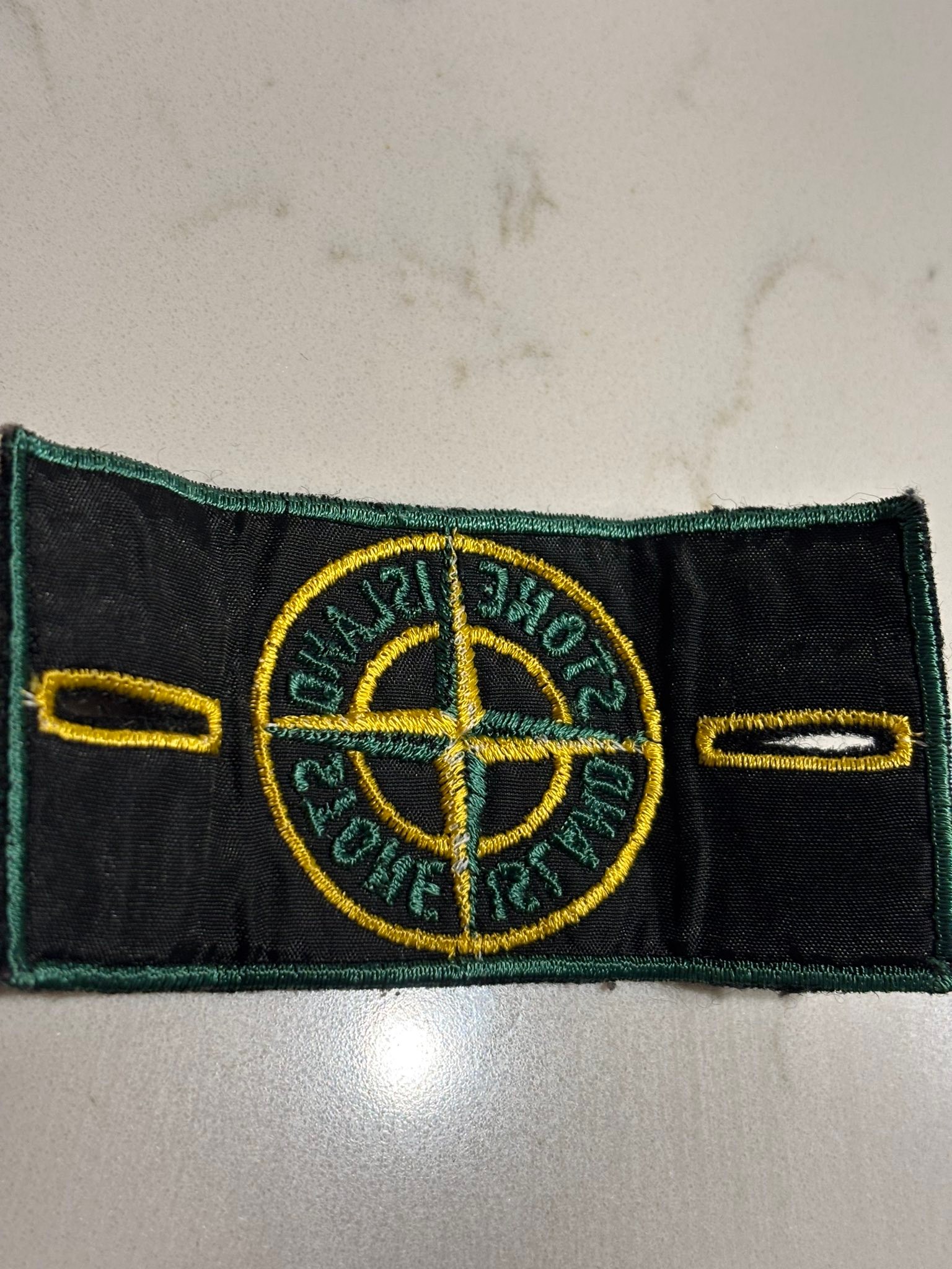 What is the Stone Island green edge badge with art number AW98?