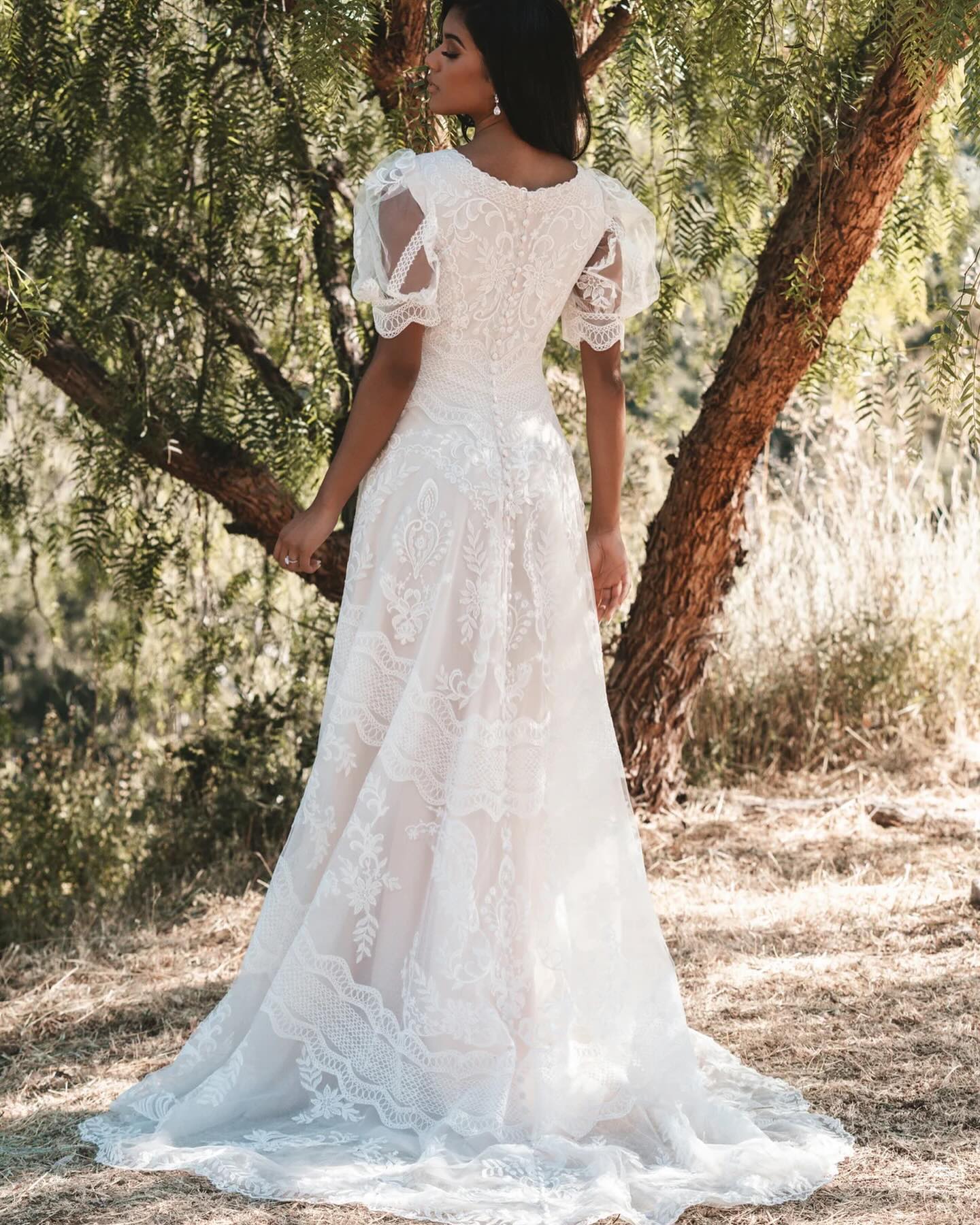 Puffed lace cap sleeves are the perfect final touch on this sweetly feminine, A-line lace wedding dress