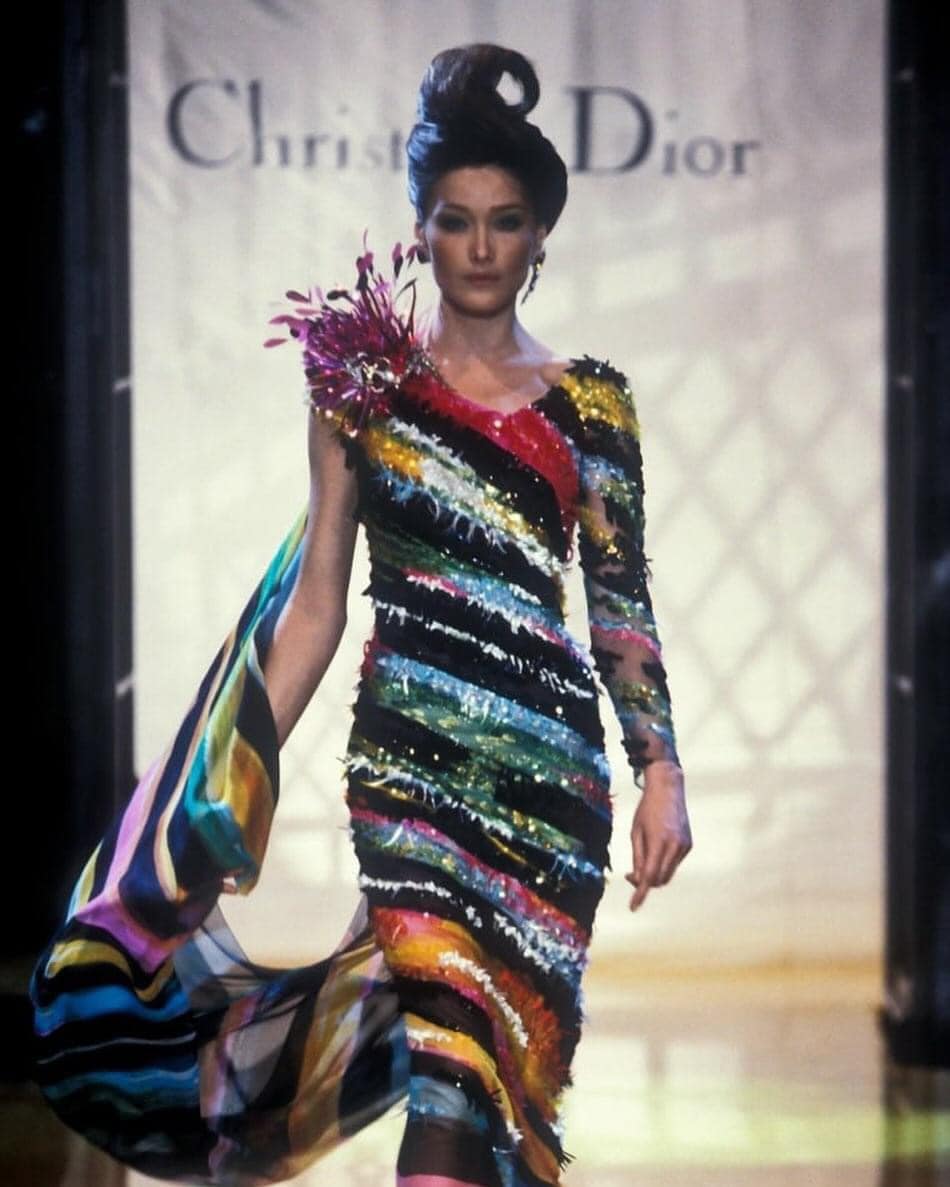 Carla Bruni in the 1990s In 1992, Carla Bruni appeared at a gala wearing a Versace jumpsuit while sipping champagne and smoking a Marlboro Light—an image that perfectly captured the atmosphere of