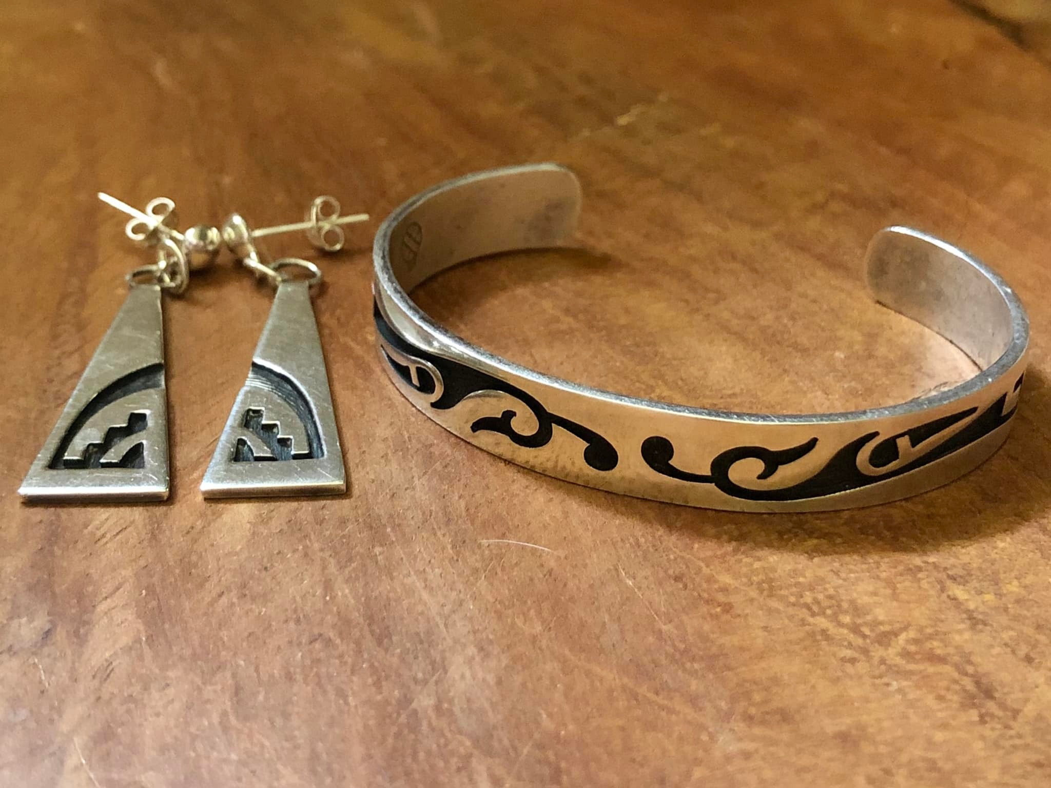 Hopi artist Roy Talahaftewa's silver earrings and gold ring