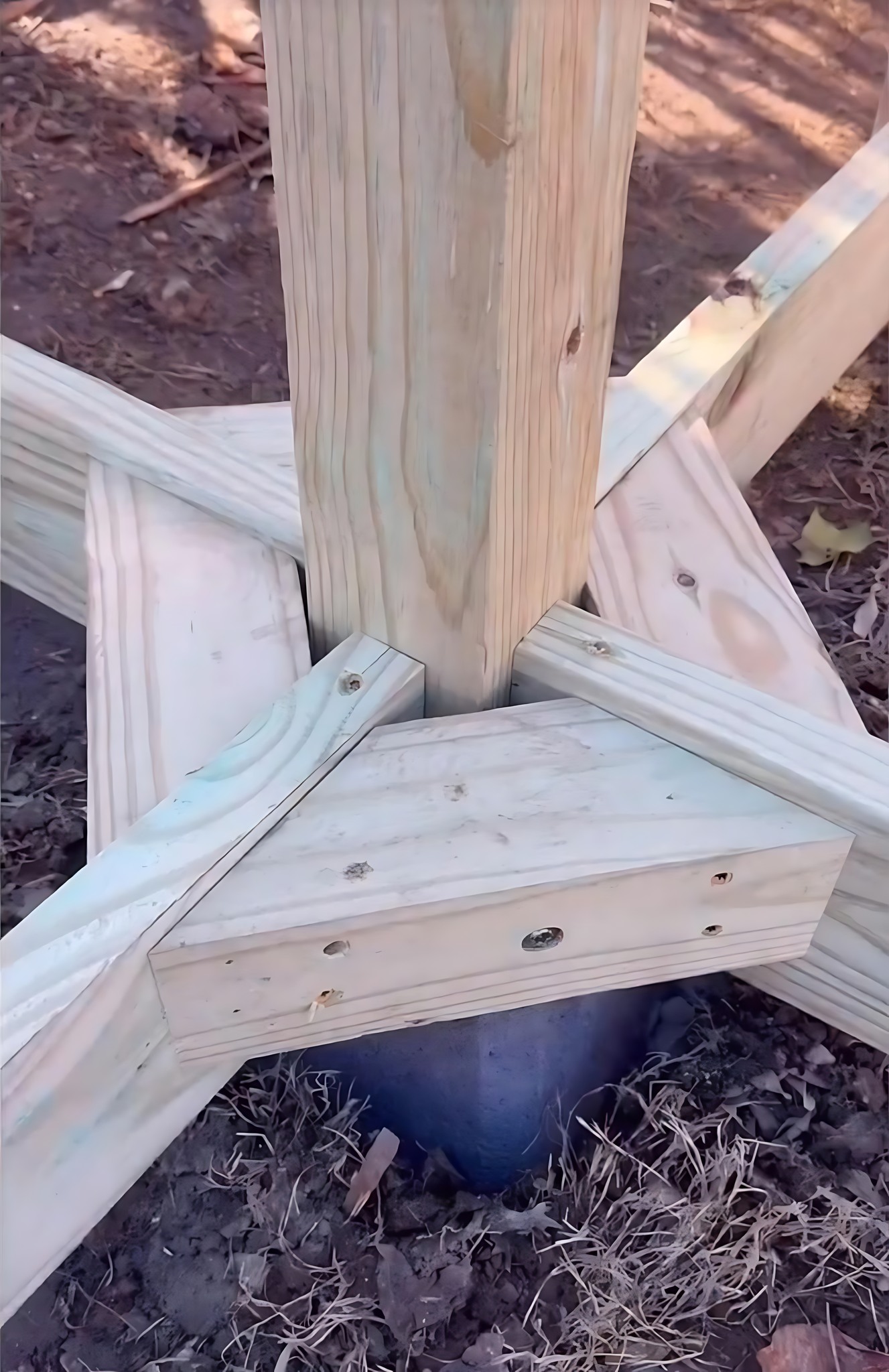 Good - A wooden post anchored to a concrete foundation block. The ...