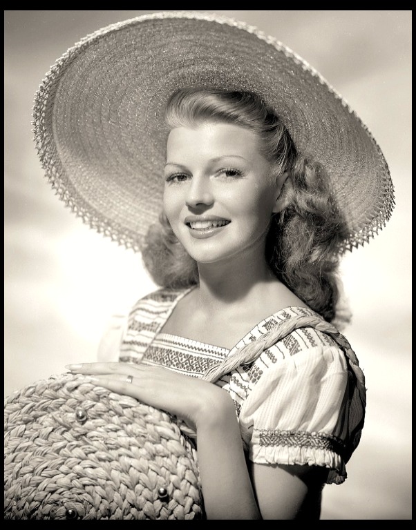 Rita Hayworth in 1948 with guitar and dog