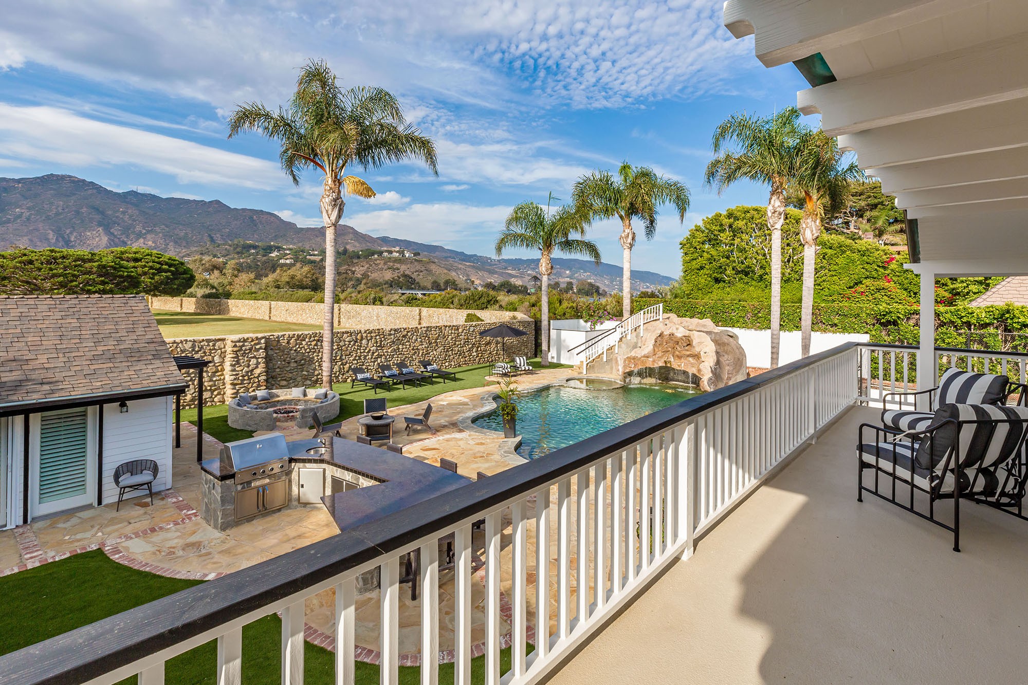 Hilton & Hyland - The private backyard oasis includes a...