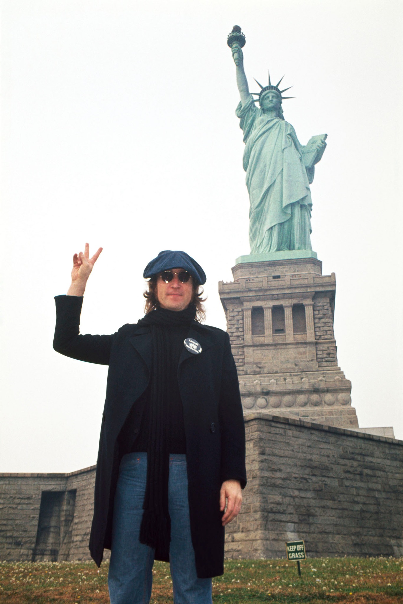John Lennon posing in front of the Statue of Liberty National
