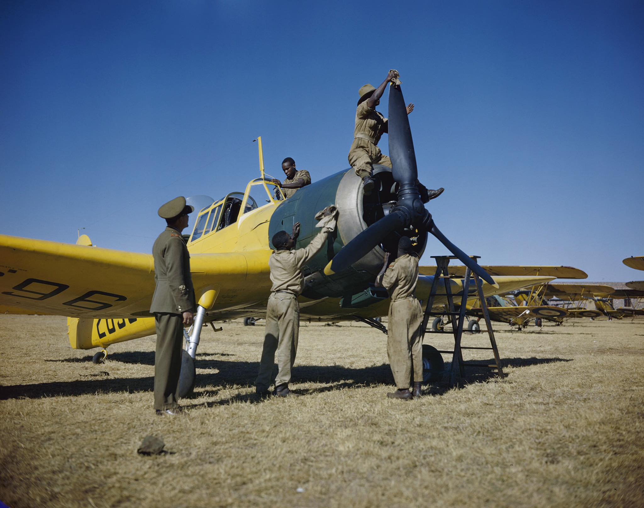 Africa - Basuto “hangar boys” cleaning and polishing a Miles Master ...